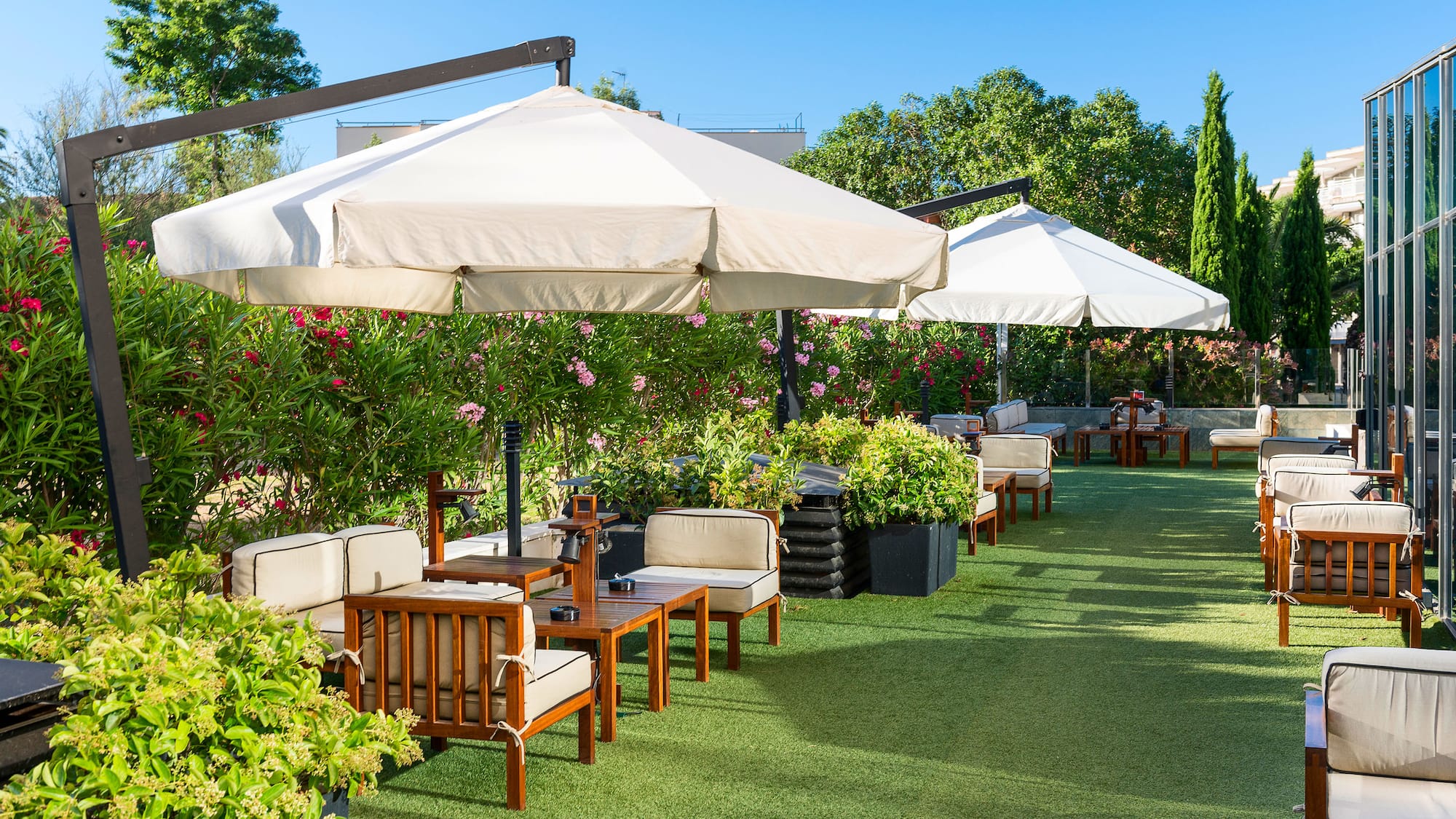 a patio area with chairs and umbrellas
