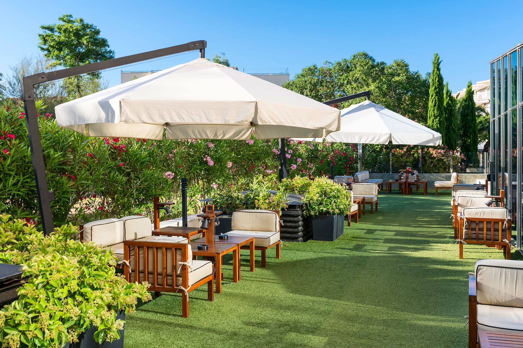 a patio area with chairs and umbrellas
