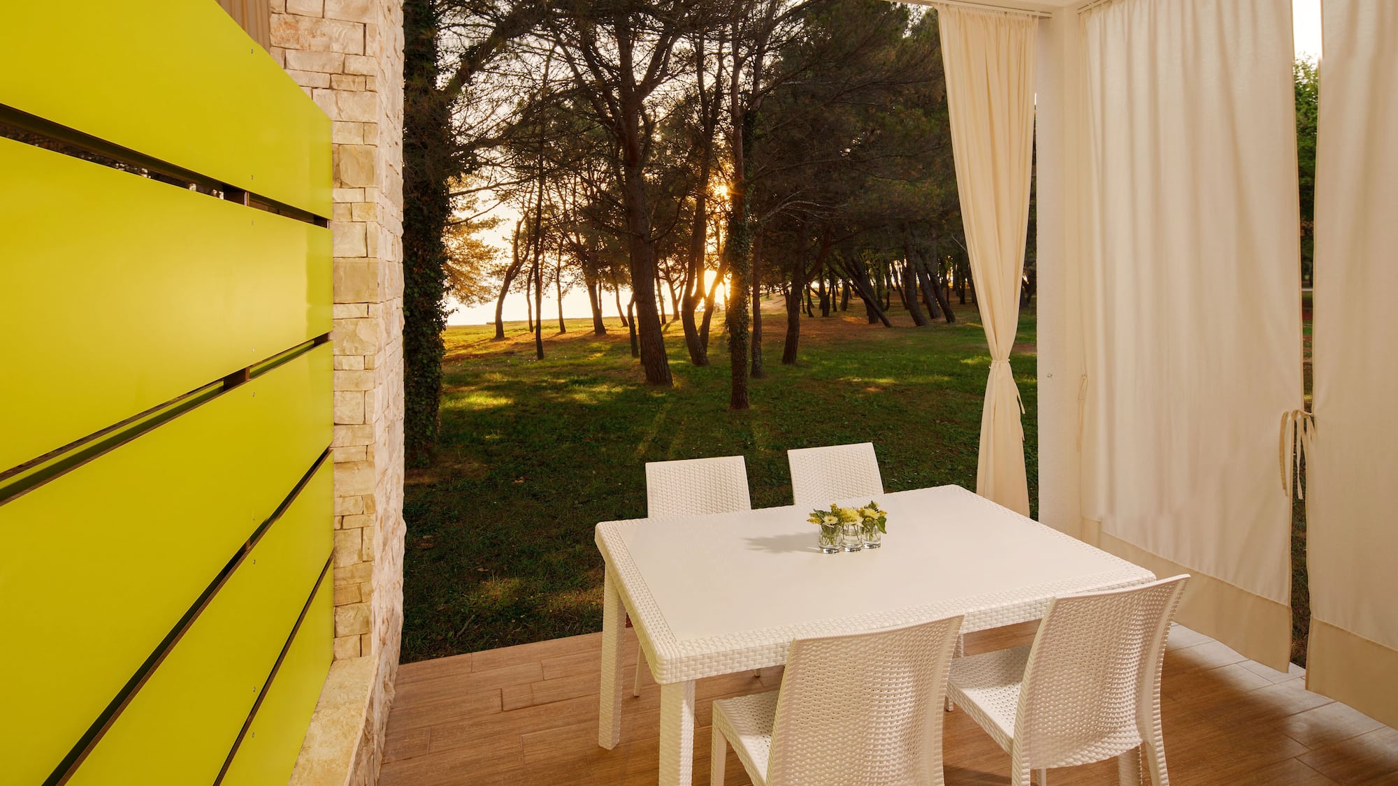 a table and chairs on a porch