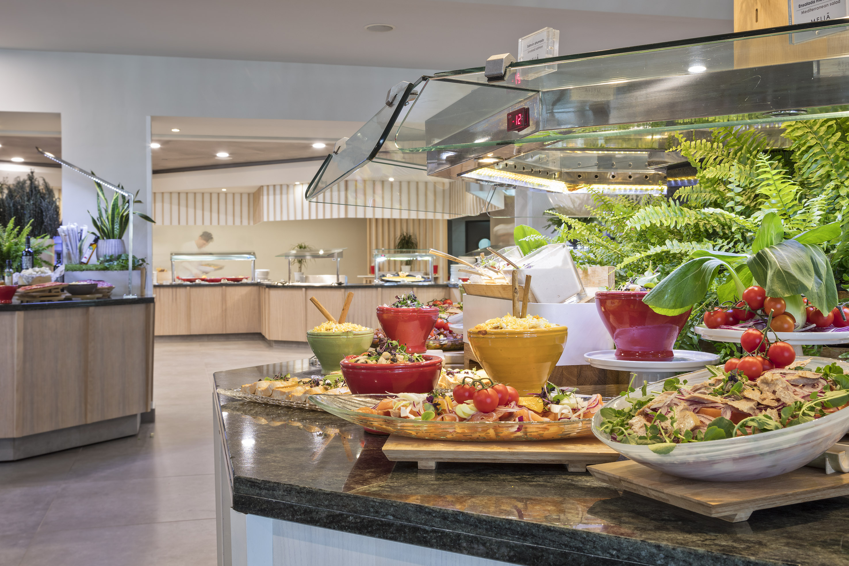 Fresh salad buffet with colorful bowls of food in a modern hotel restaurant.
