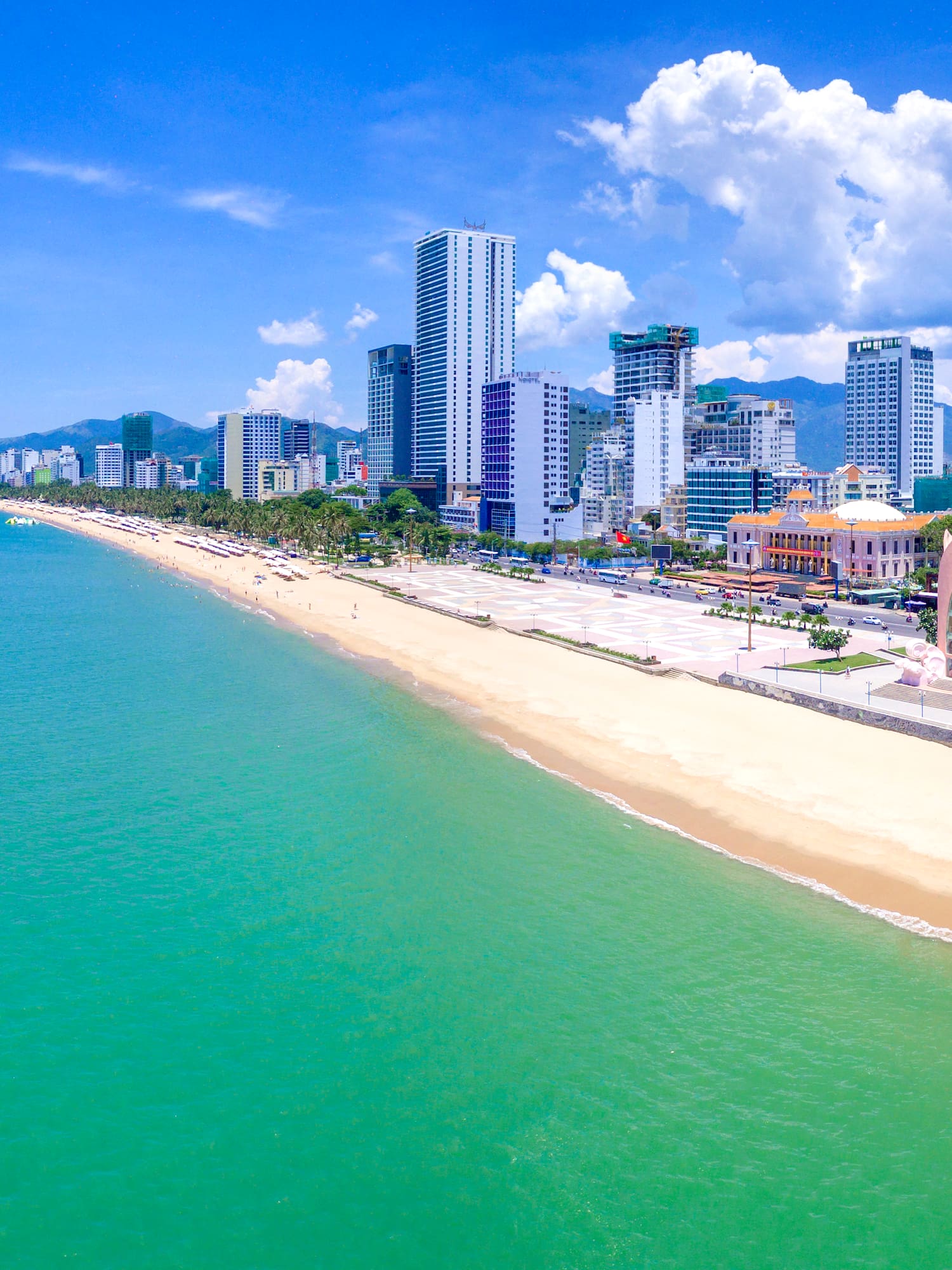 a beach with buildings and a body of water