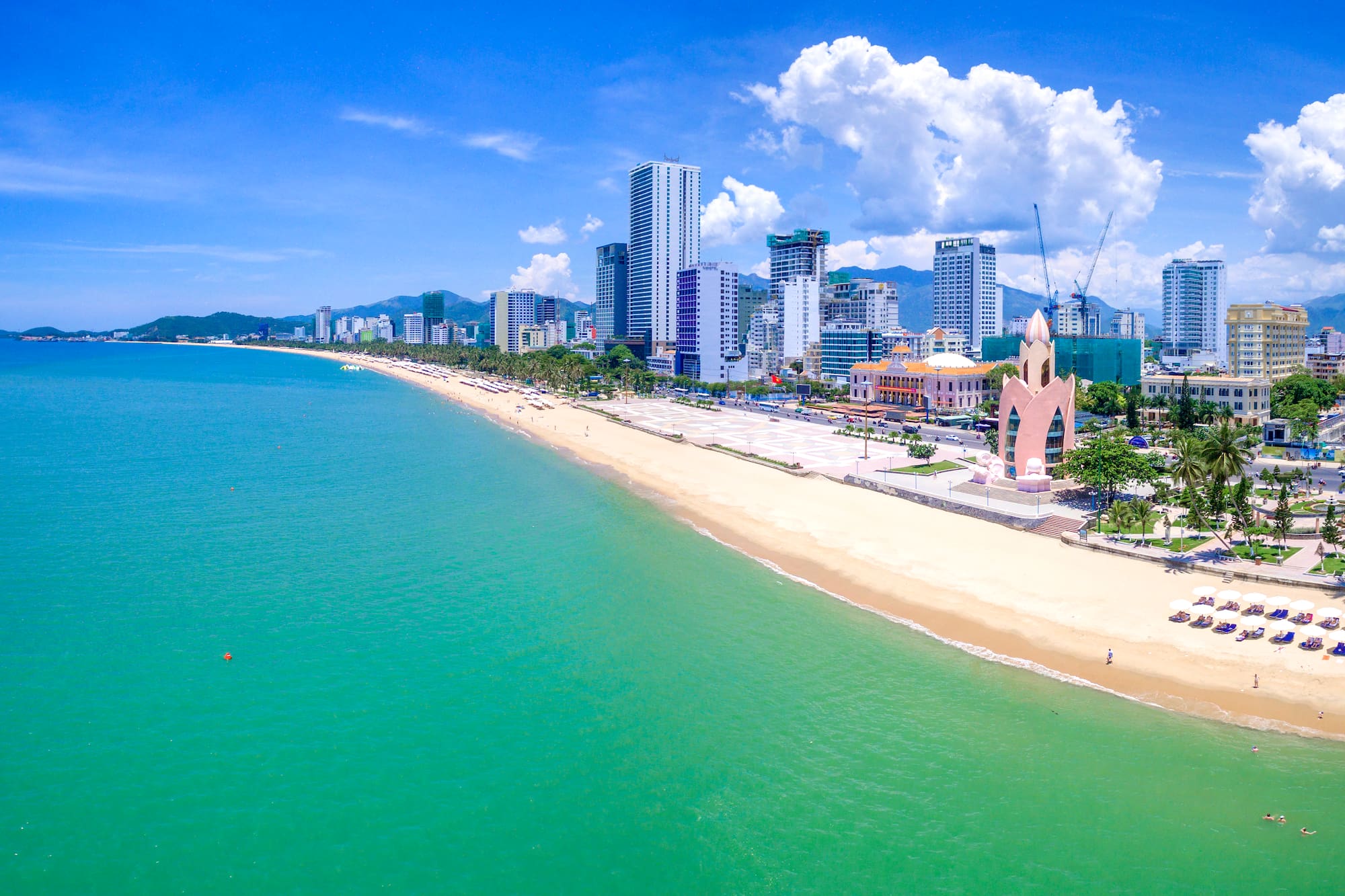 a beach with buildings and a body of water