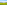 a green field with trees and mountains in the background