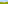 a green field with trees and mountains in the background