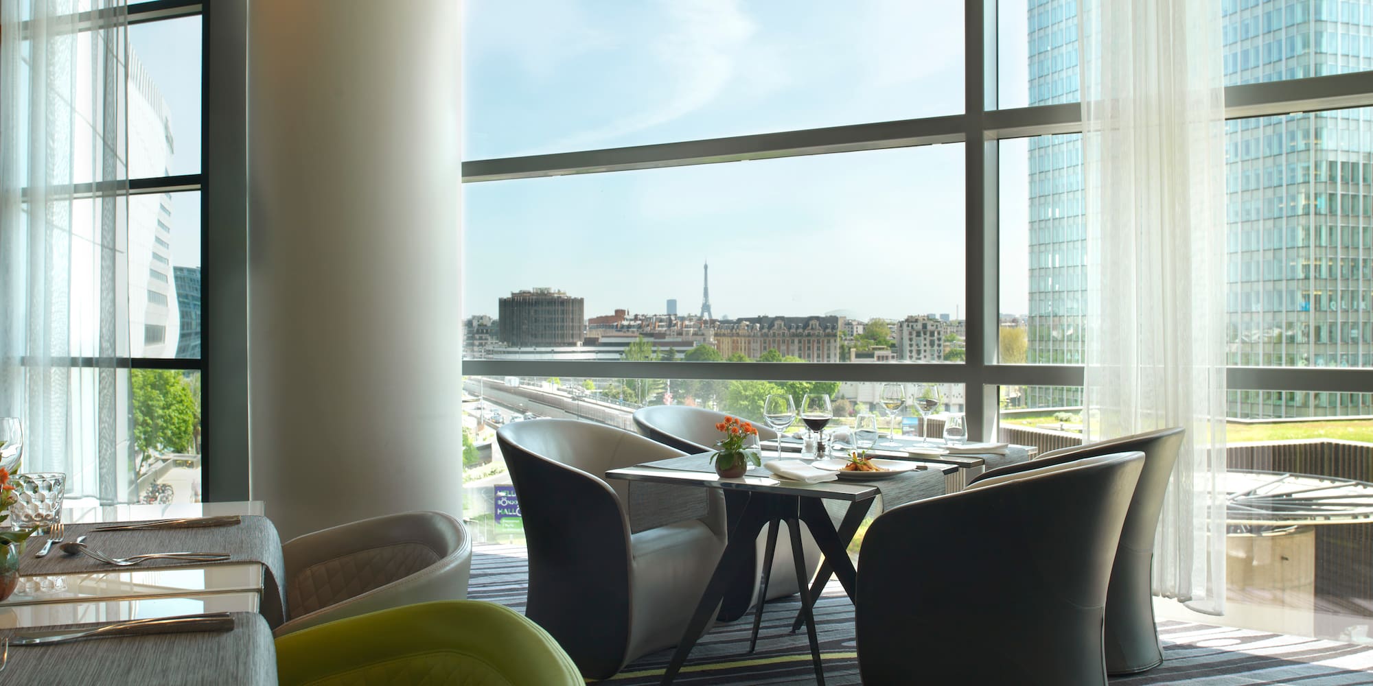 a room with a large window and a table and chairs