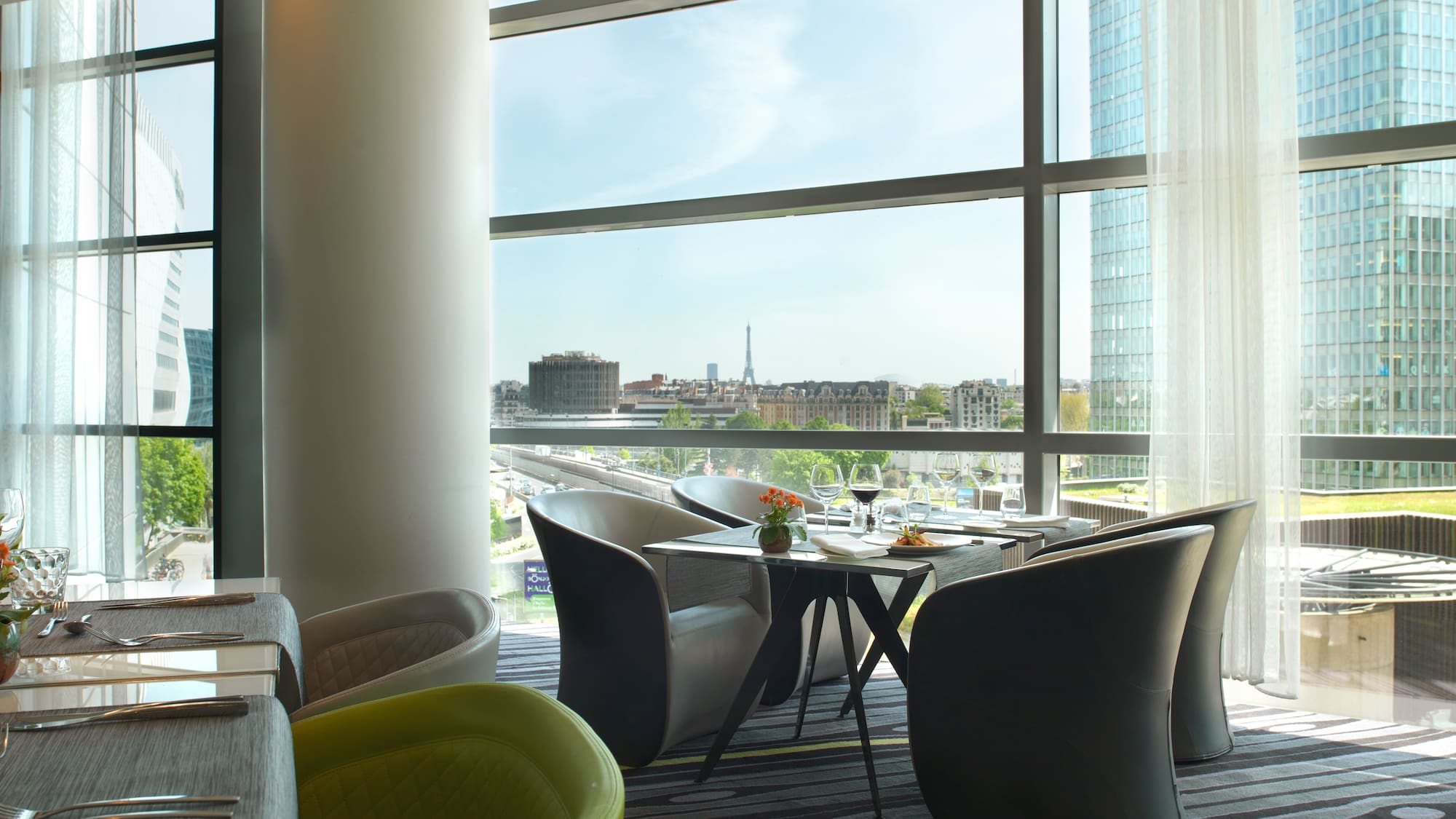 a room with a large window and a table and chairs