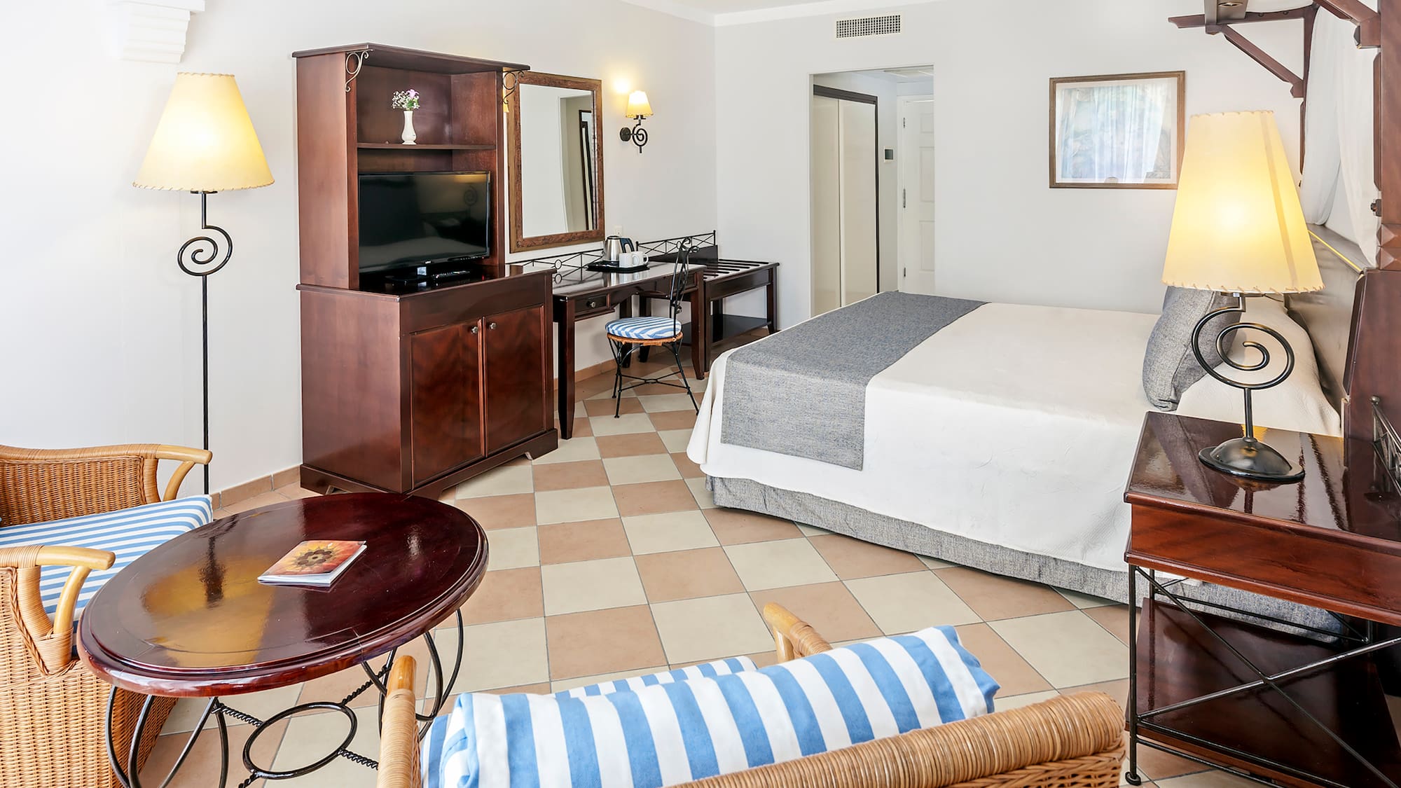 a room with a bed and a television