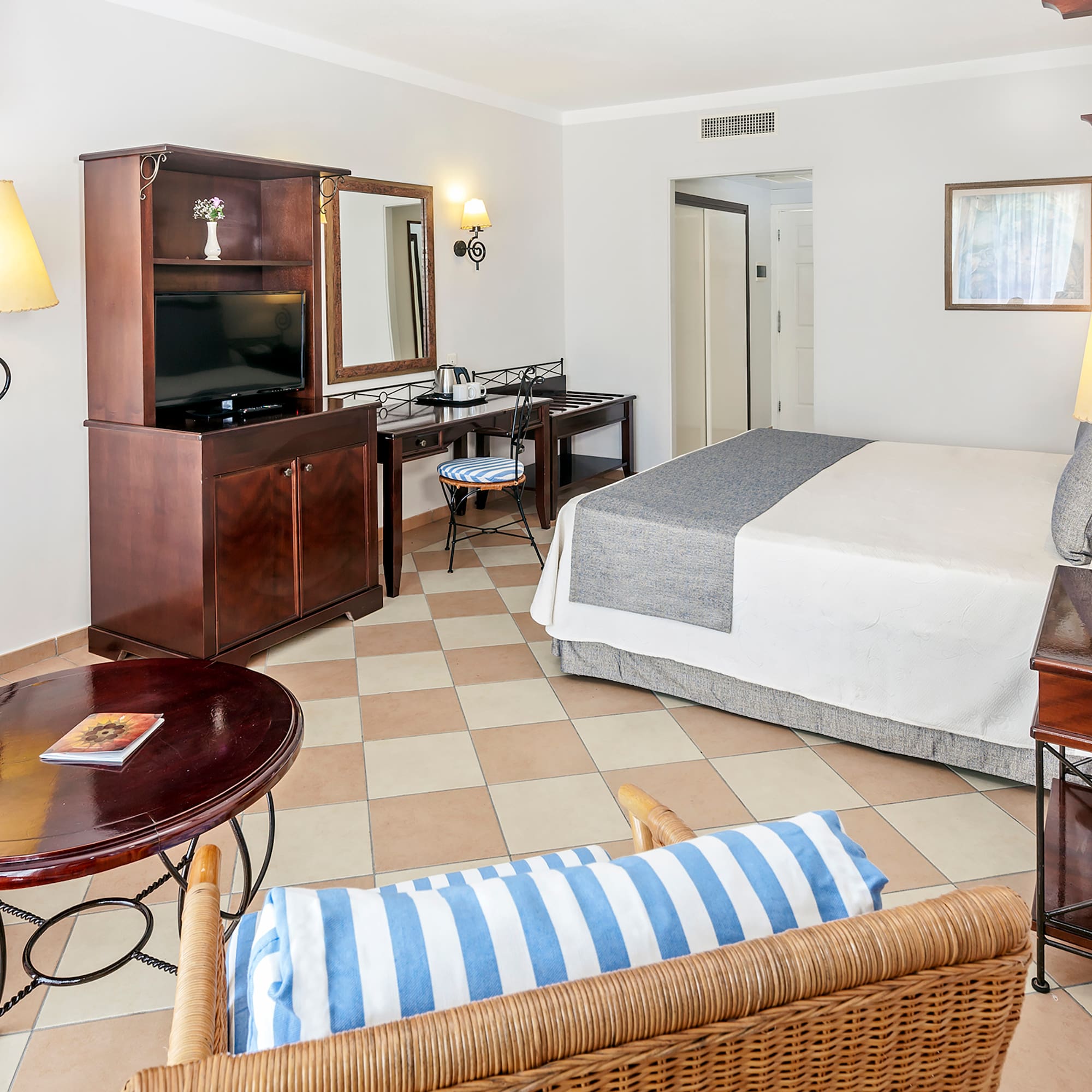 a room with a bed and a television