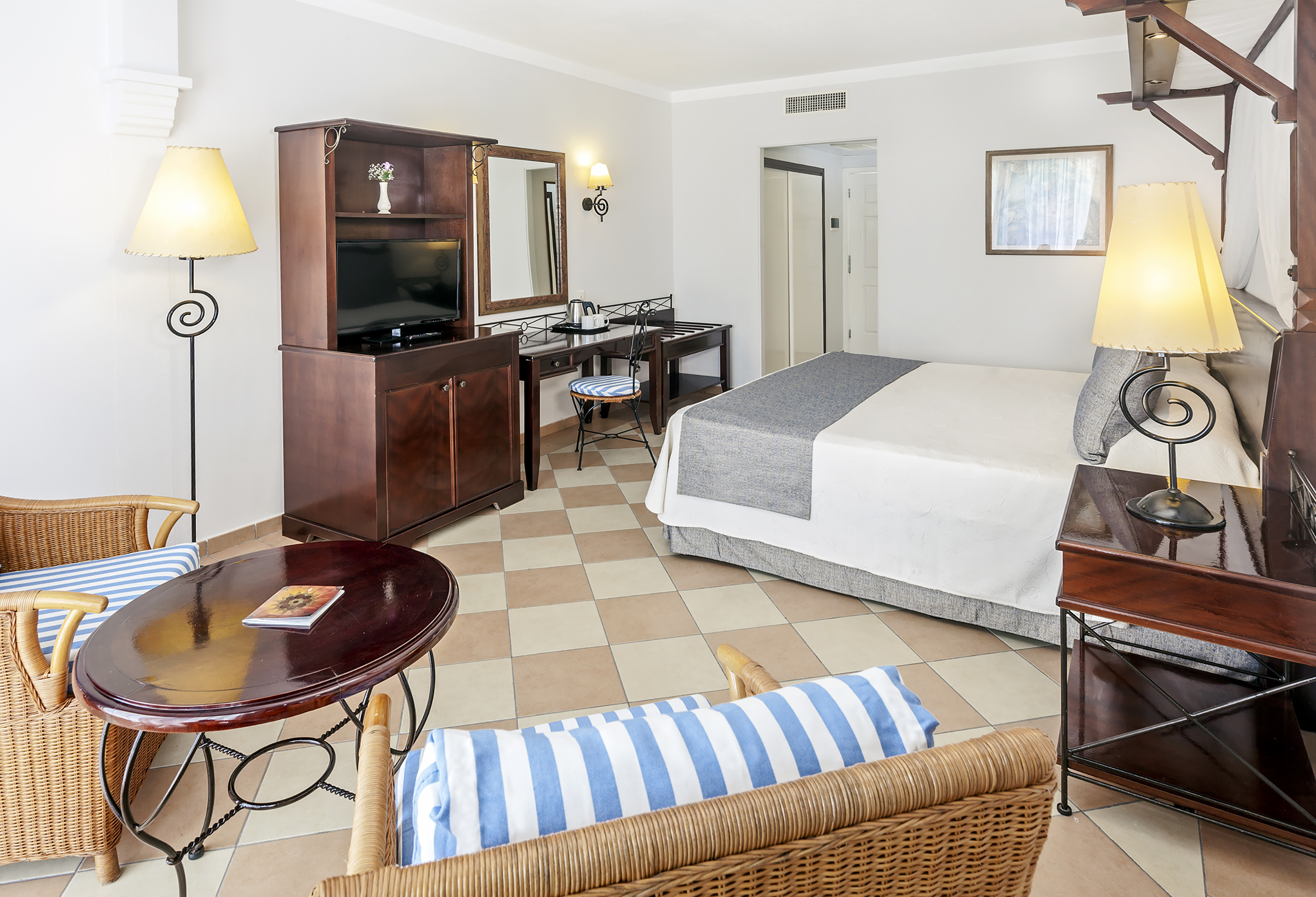 a room with a bed and a television