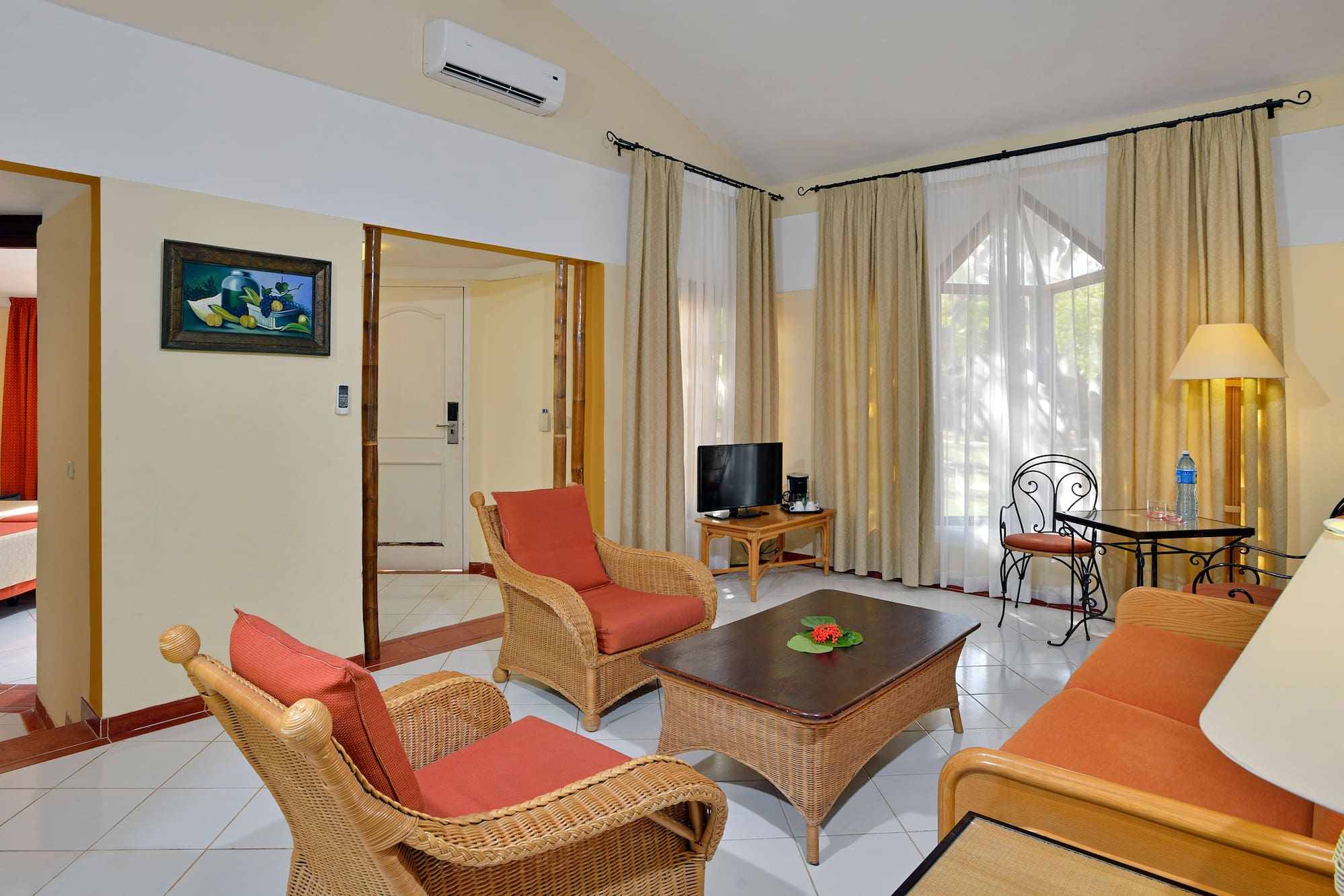 a living room with wicker furniture and a table