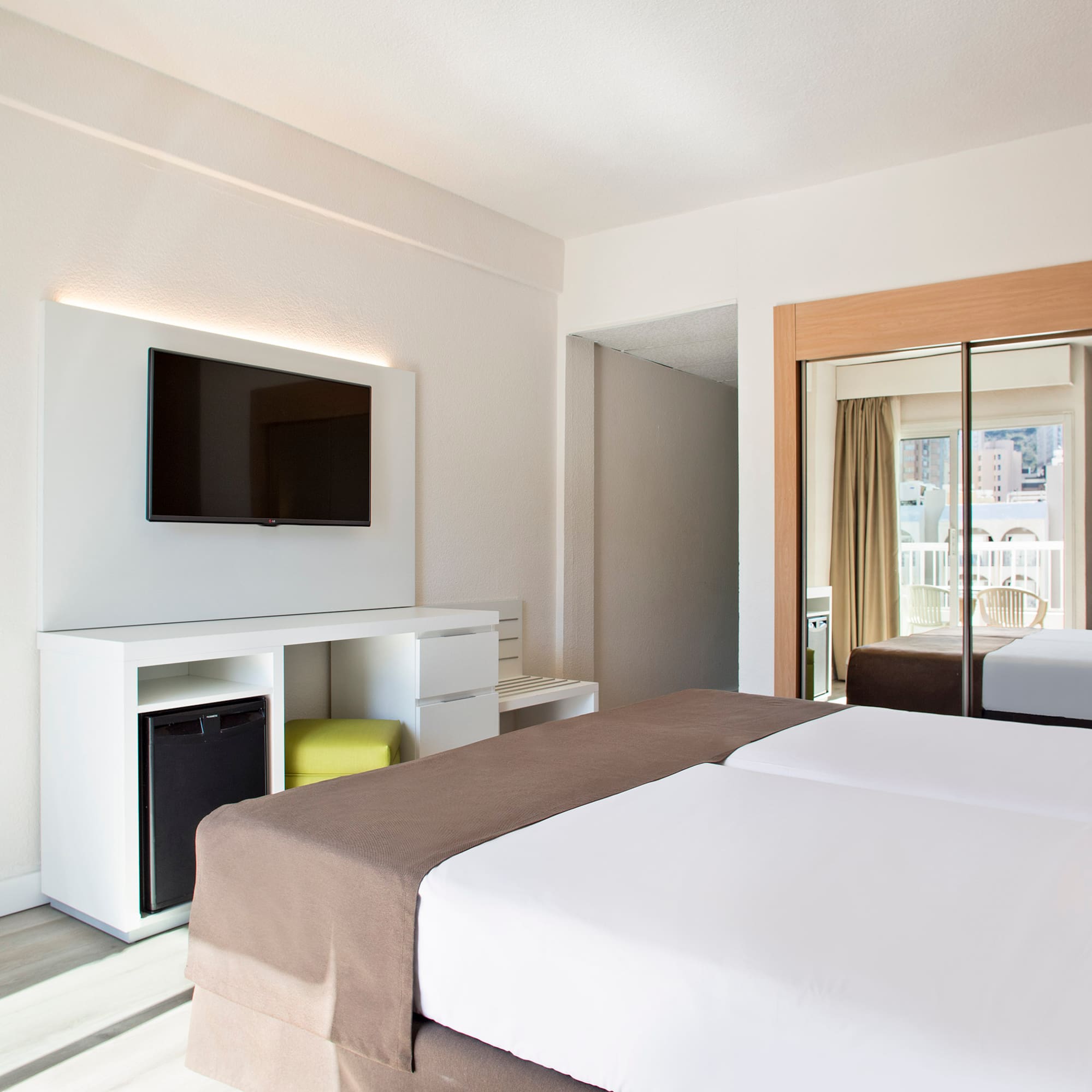 a room with a bed and a television