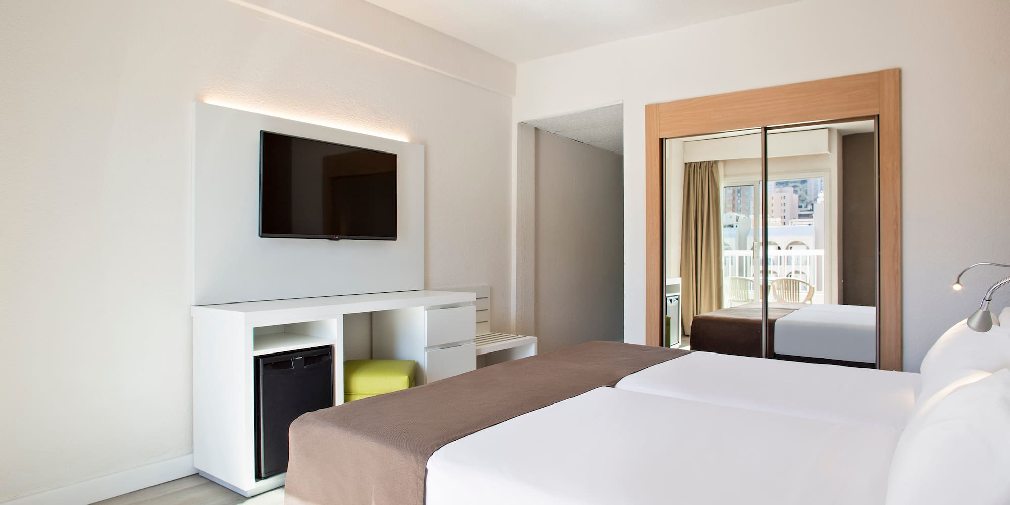 a room with a bed and a television