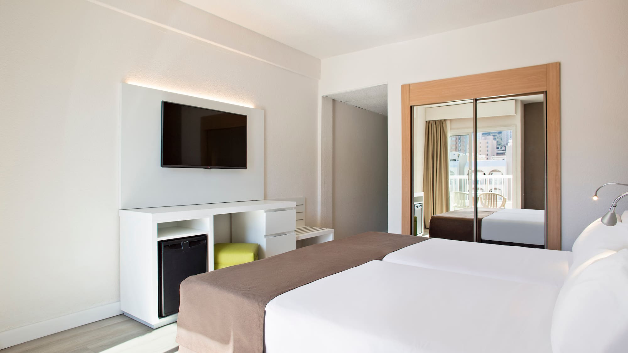 a room with a bed and a television