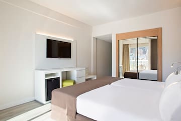 a room with a bed and a television