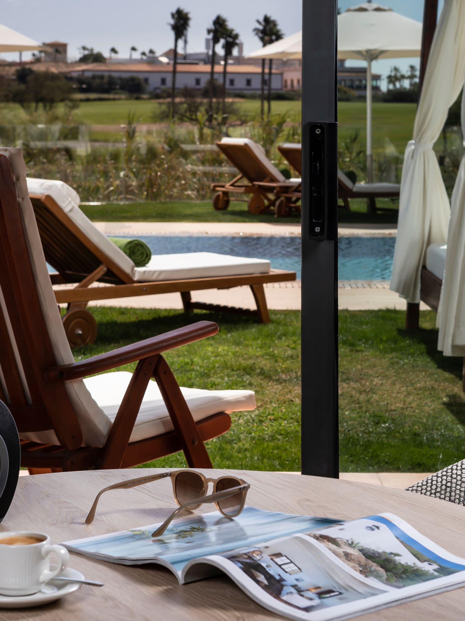a table with a cup of coffee and a speaker on it
