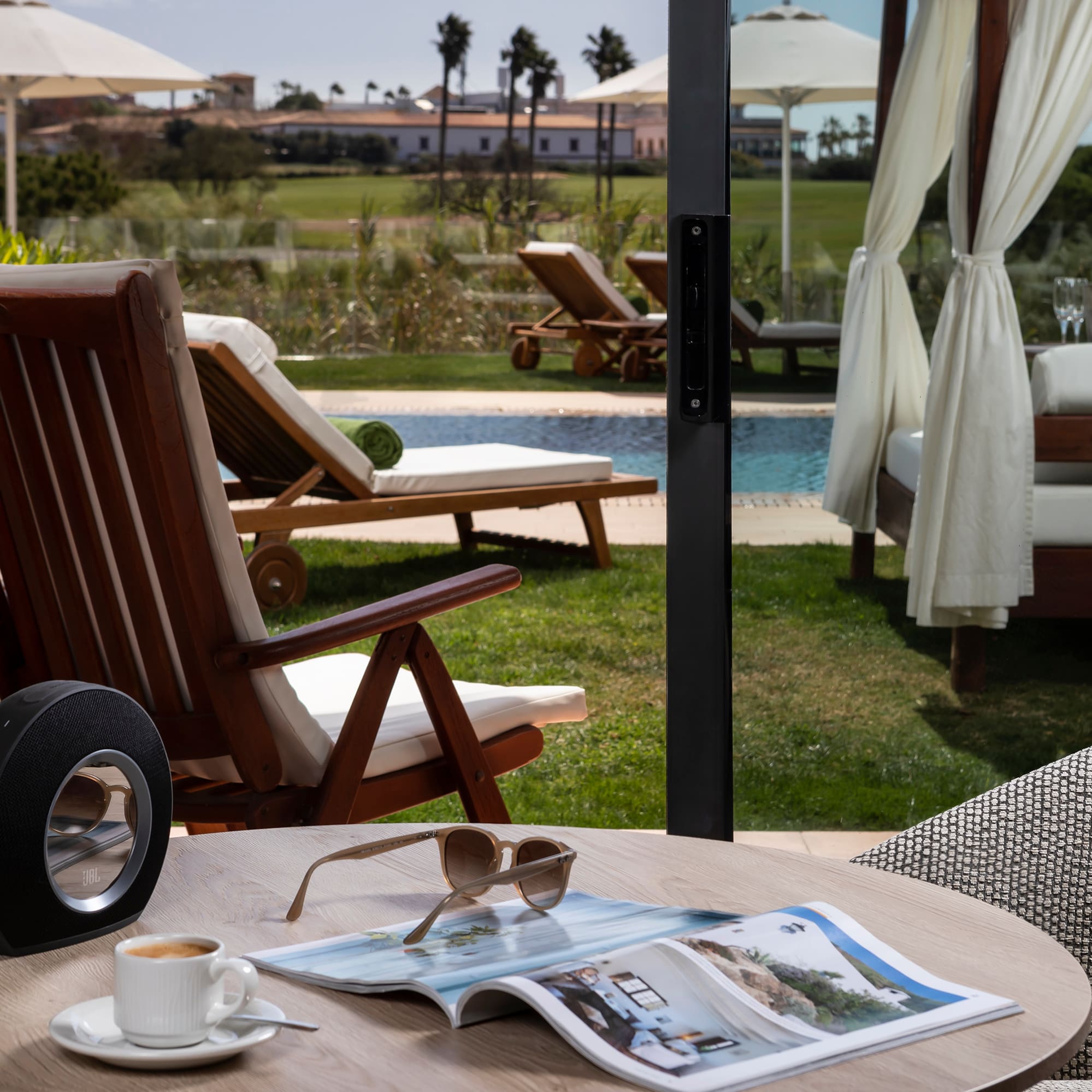 a table with a cup of coffee and a speaker on it