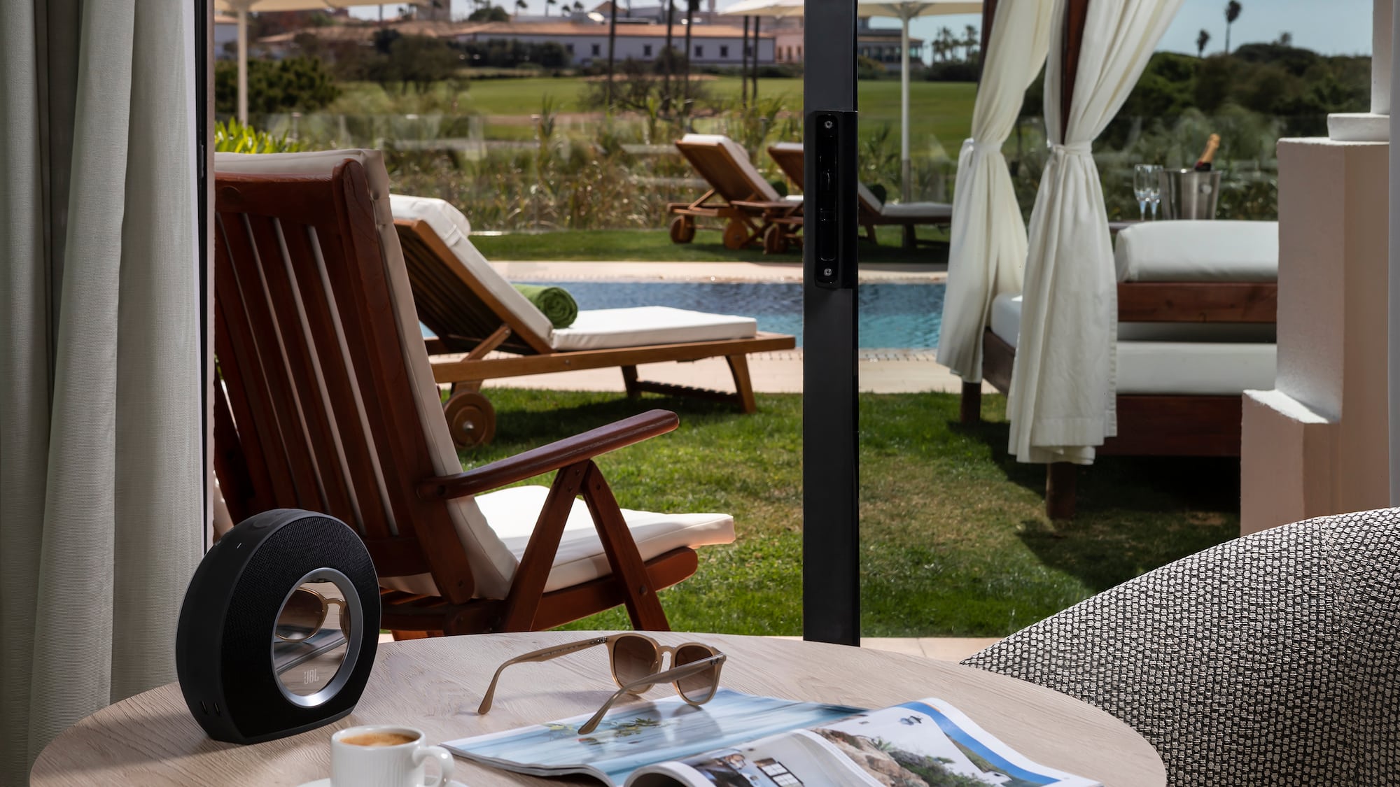 a table with a cup of coffee and a speaker on it