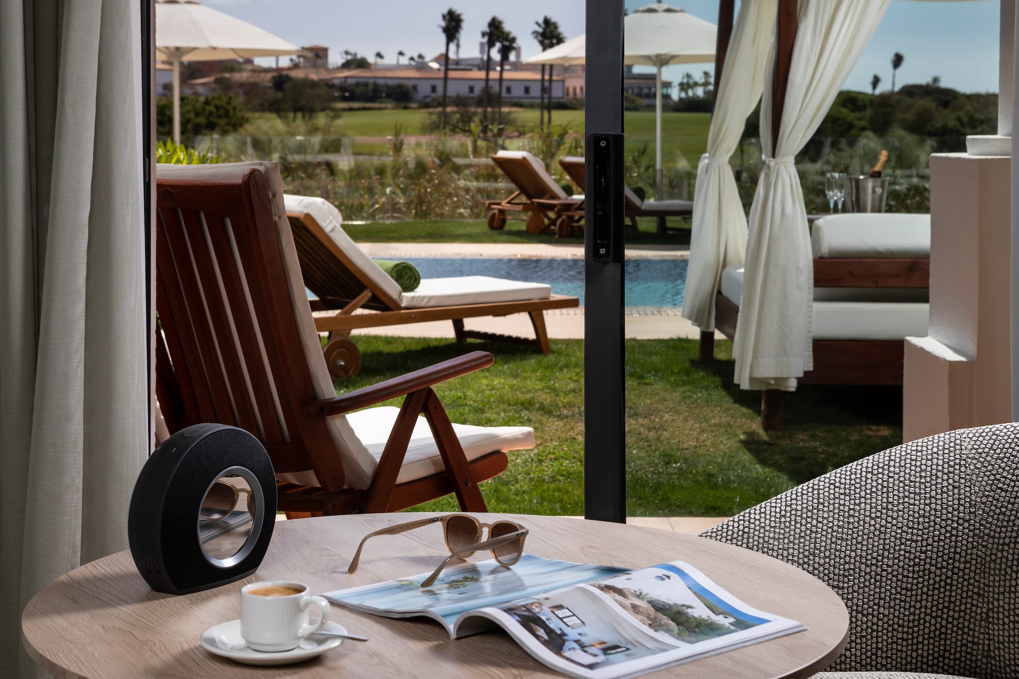 a table with a cup of coffee and a speaker on it