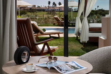 a table with a cup of coffee and a speaker on it