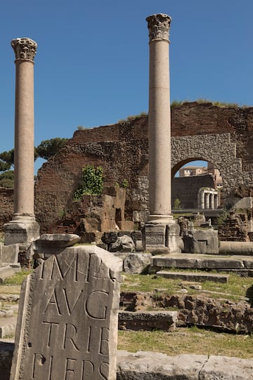 a stone ruins with columns and a stone arch