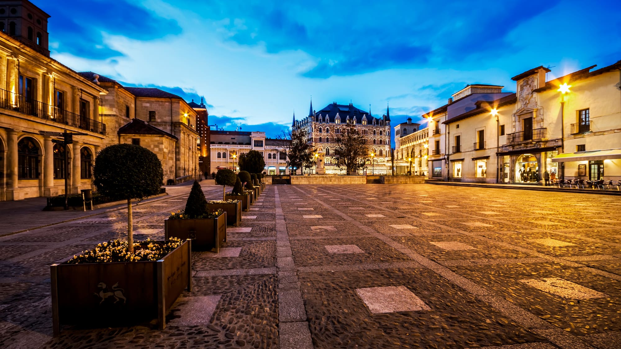 a courtyard with a building in the background