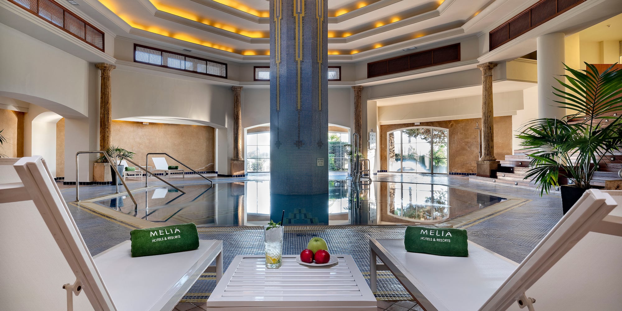 a pool with chairs and a table