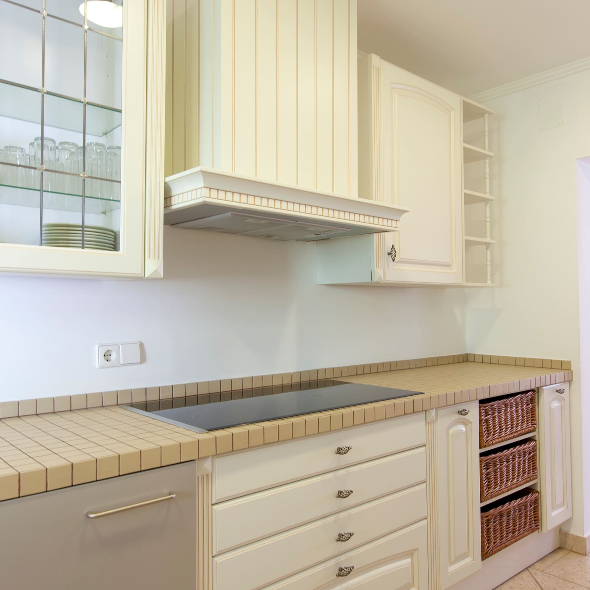 a kitchen with white cabinets and white counter tops