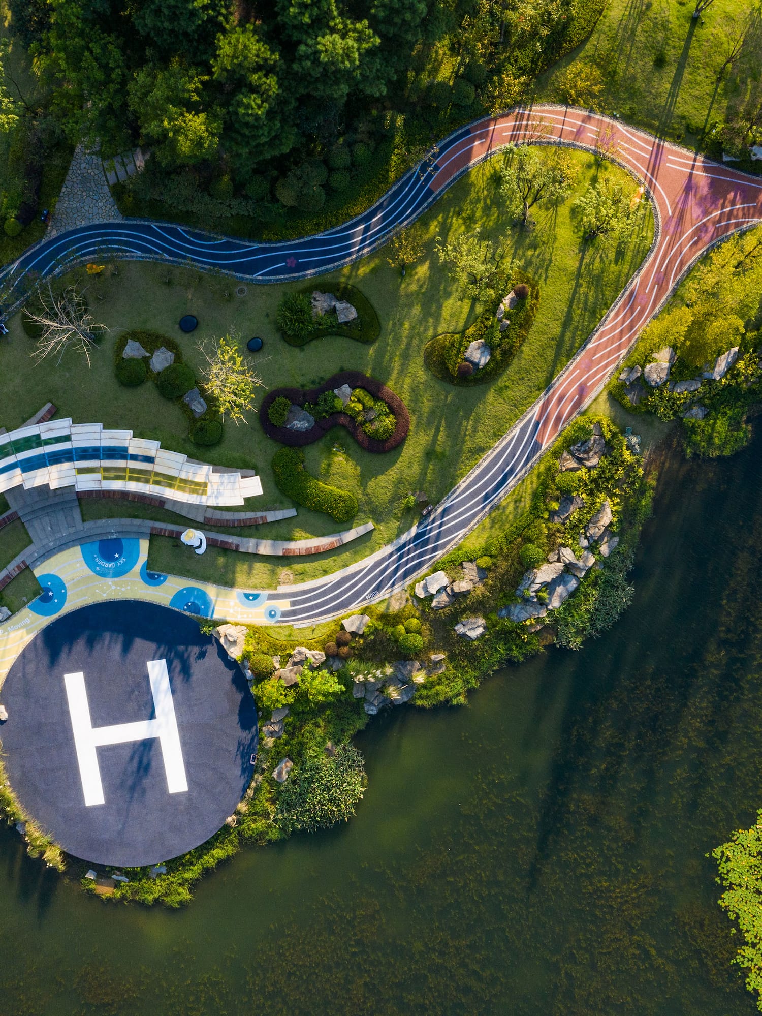 aerial view of a helicopter landing pad on a small island with a river