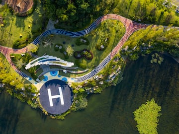 aerial view of a helicopter landing pad on a small island with a river