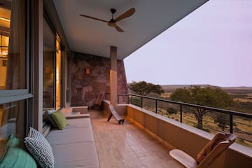 a balcony with a couch and a fan