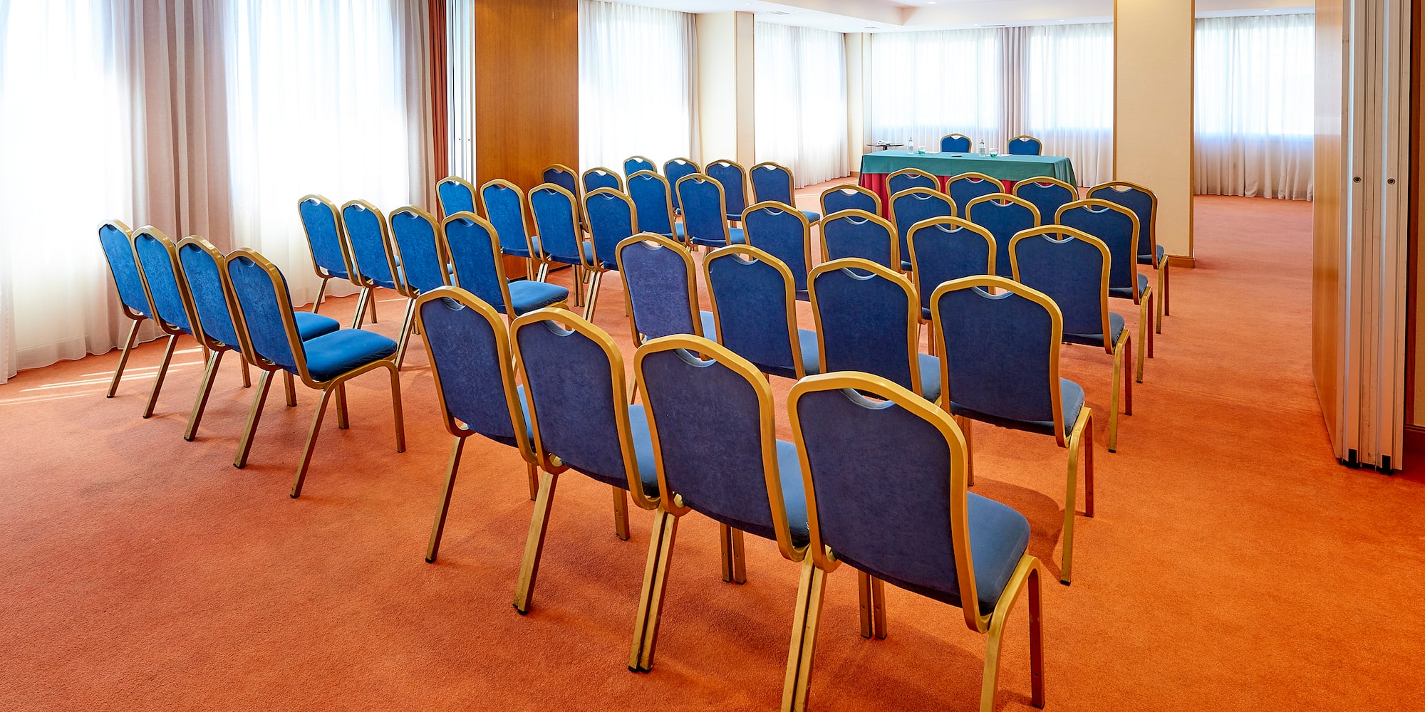 a room with blue chairs and a table