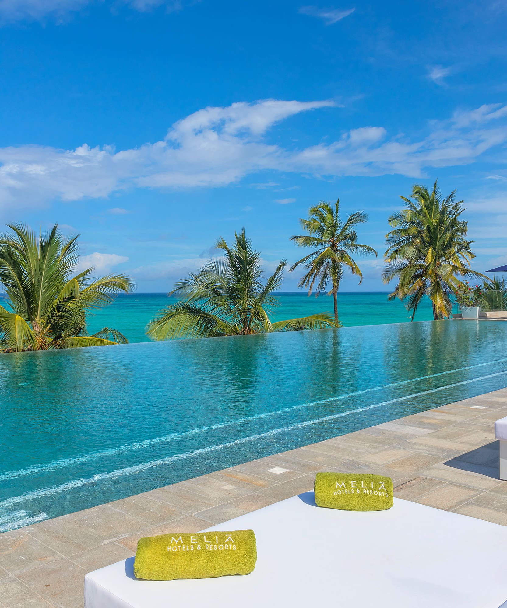 a pool with palm trees and a blue sky
