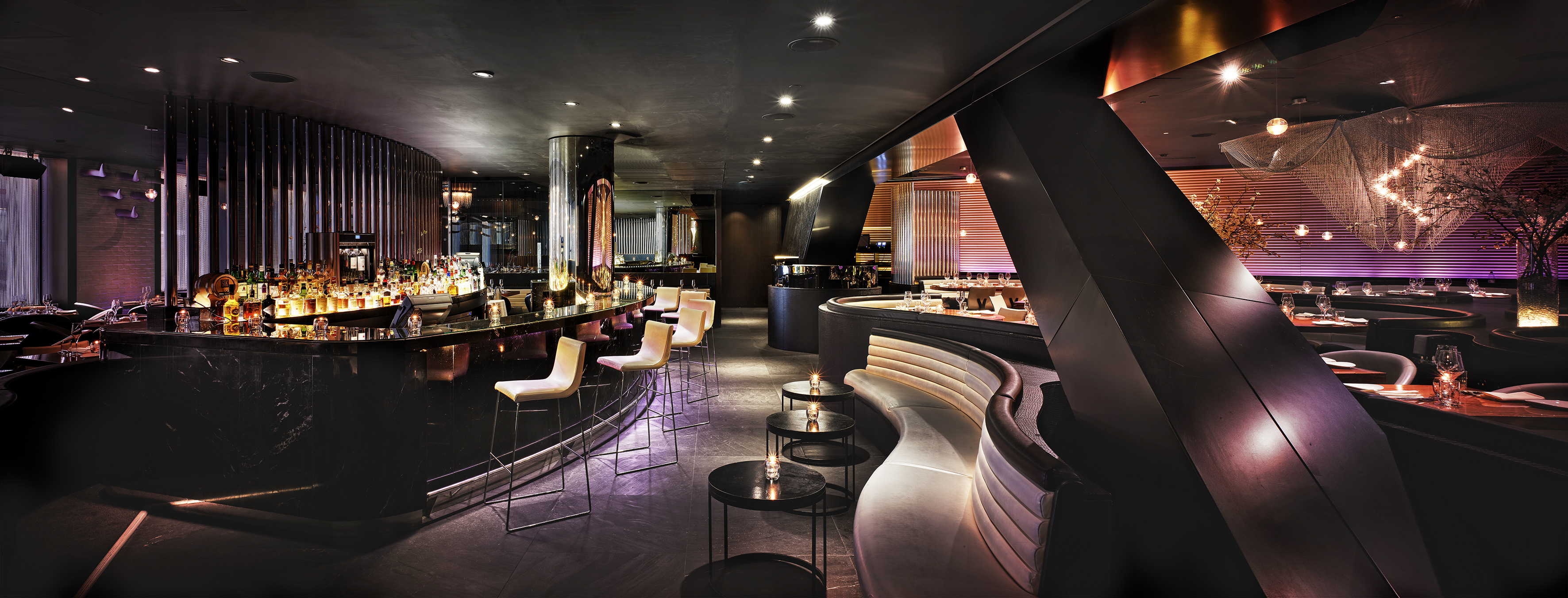 a room with a bar and a long curved bench