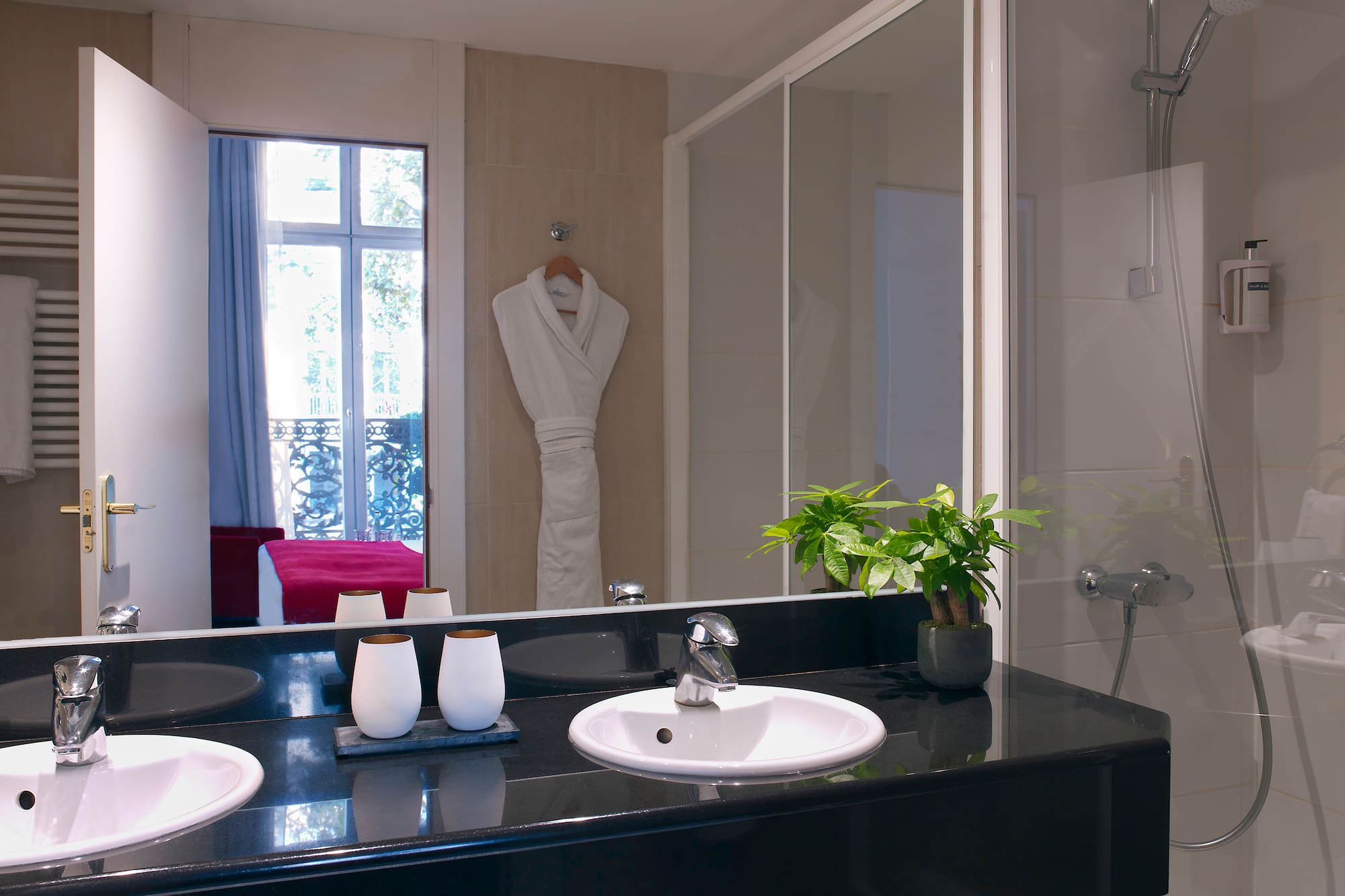 a bathroom with a black countertop and a white bathrobe