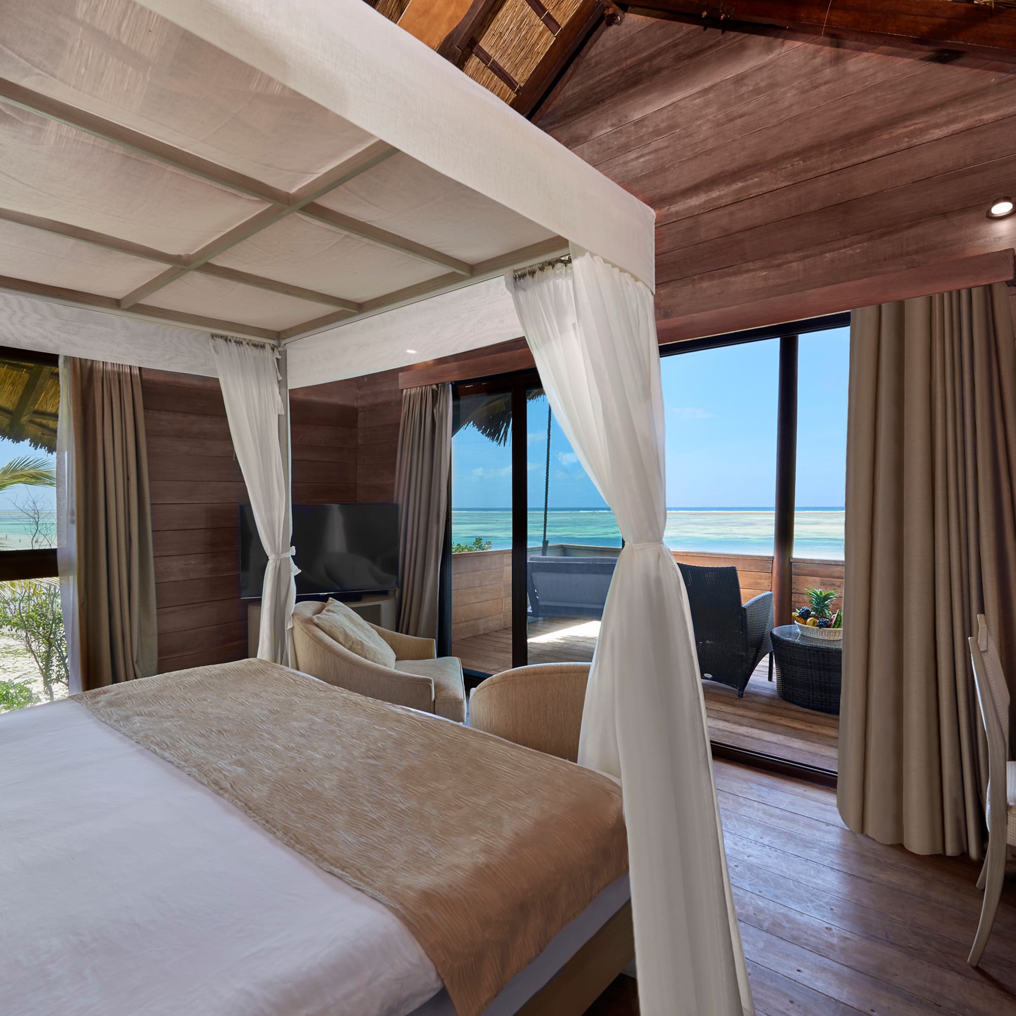 a room with a bed and a chair and a table