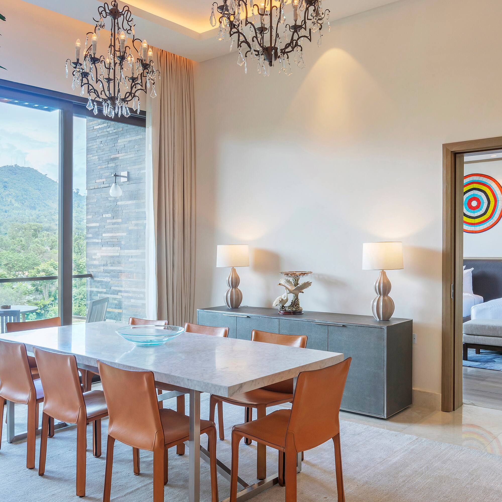 a dining table and chairs in a room with a large window