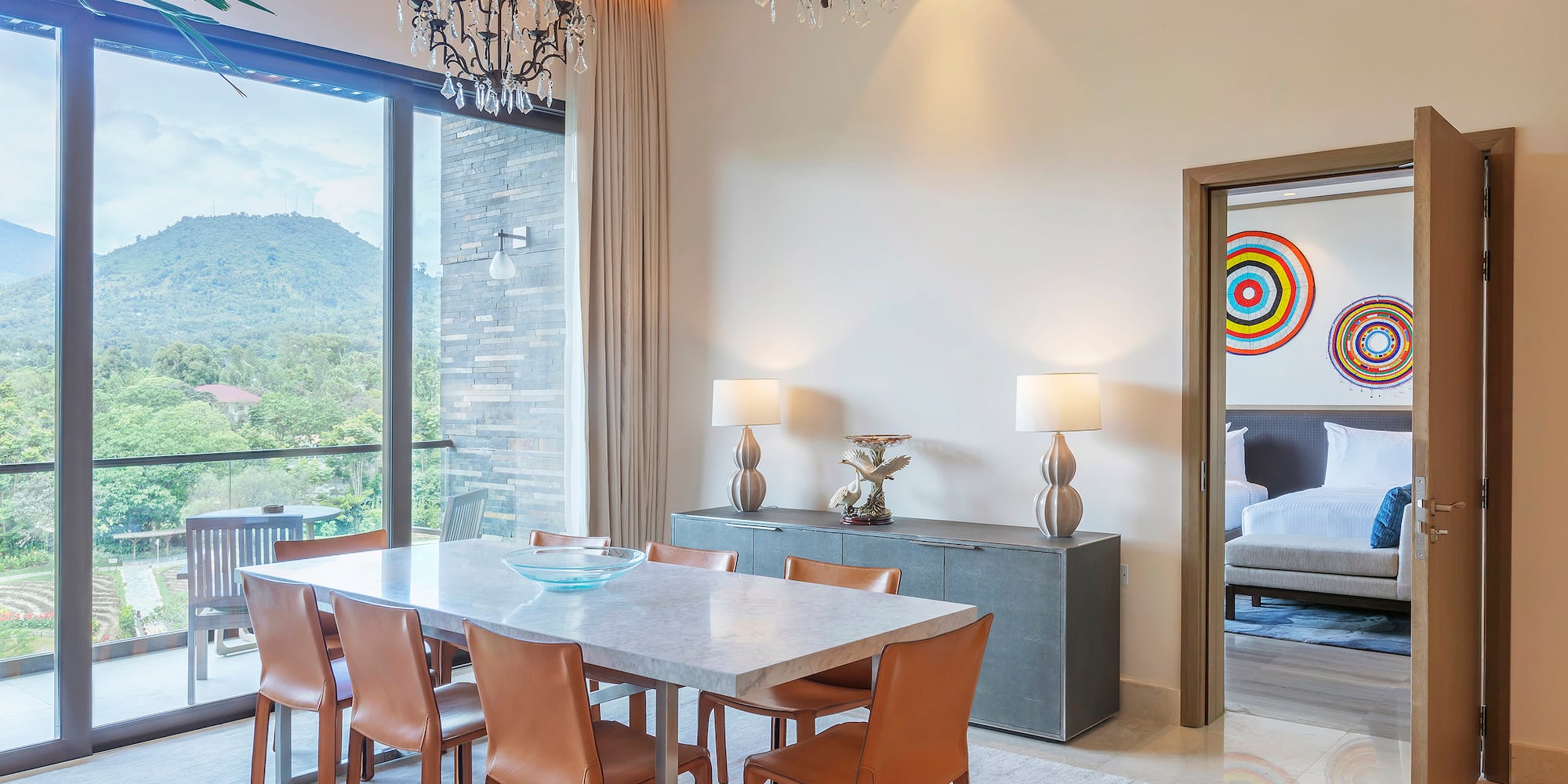 a dining table and chairs in a room with a large window