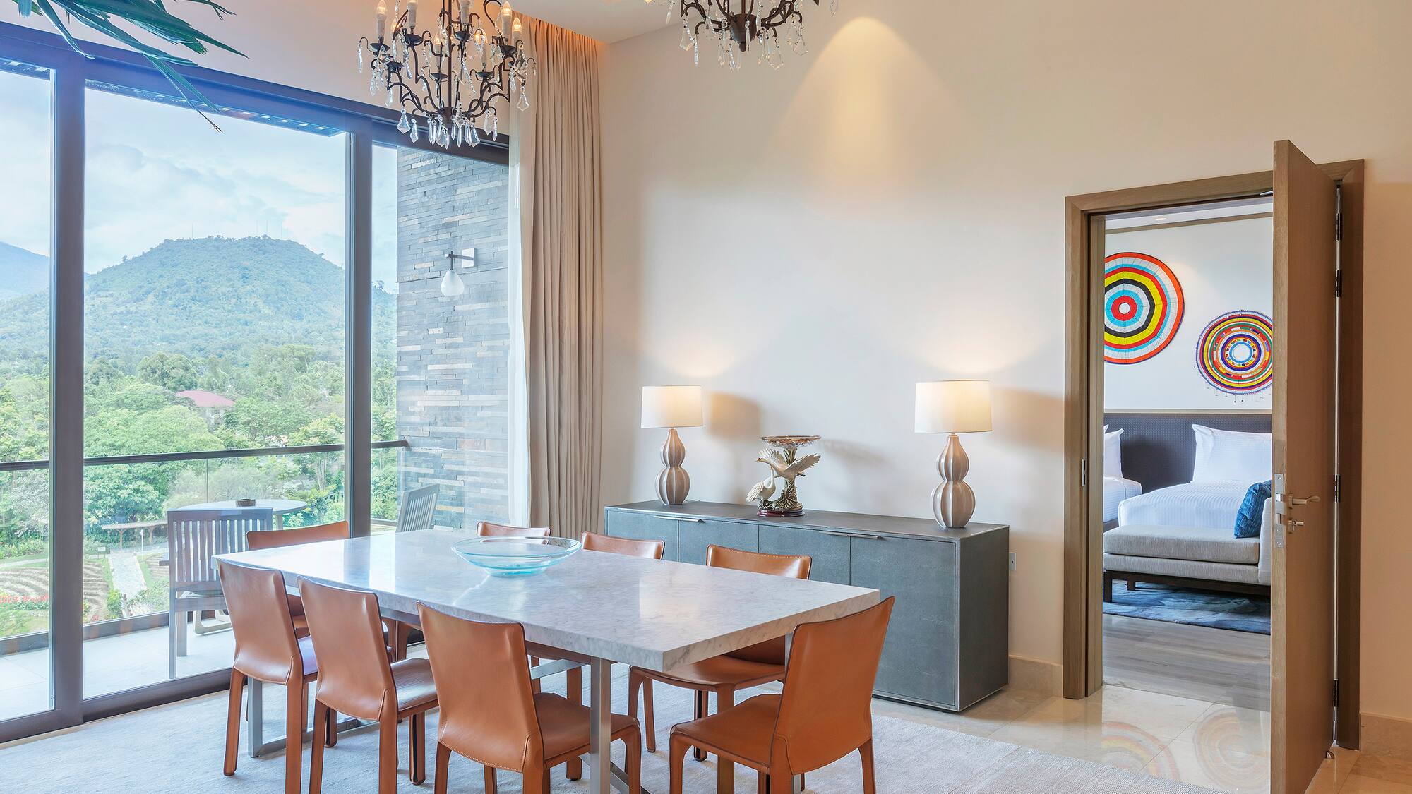 a dining table and chairs in a room with a large window