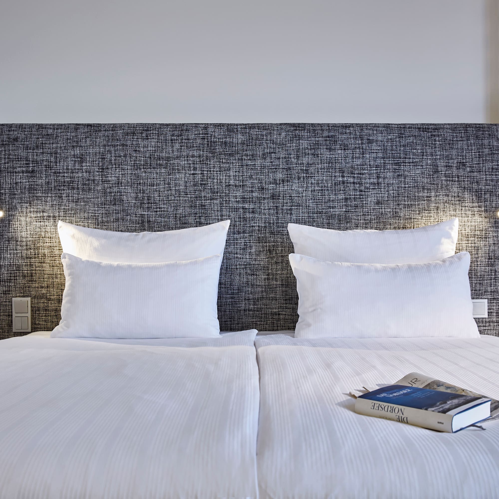 a bed with a book on it