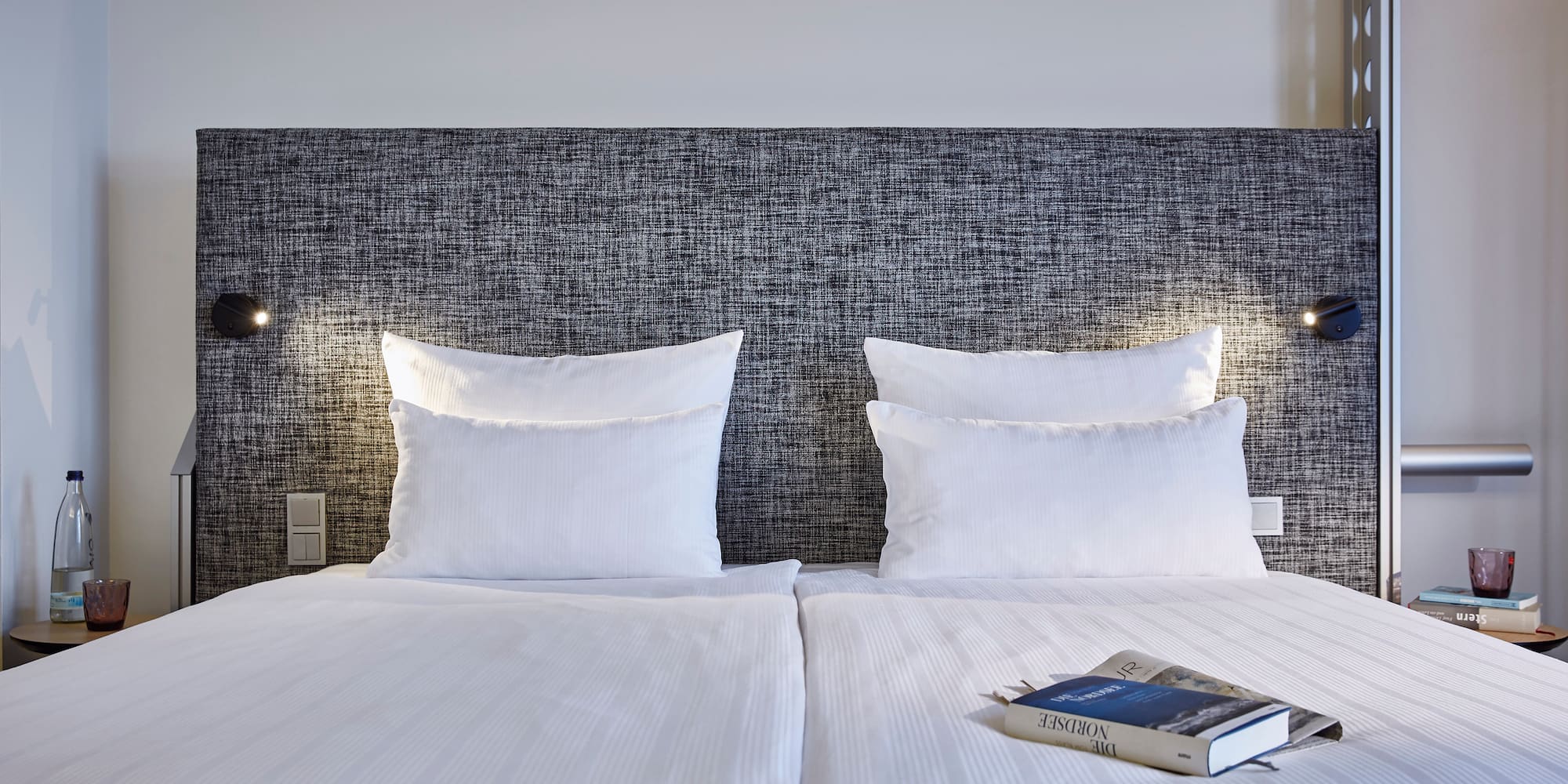 a bed with a book on it