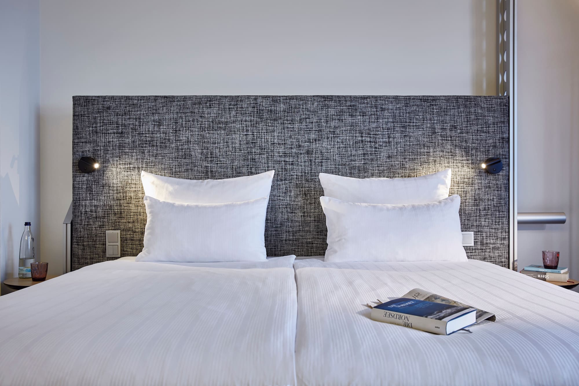 a bed with a book on it