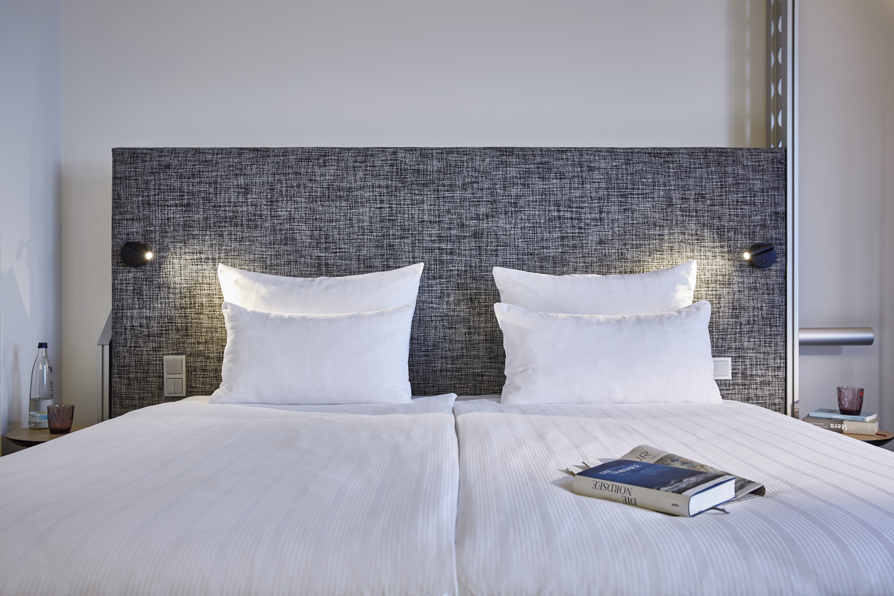 a bed with a book on it