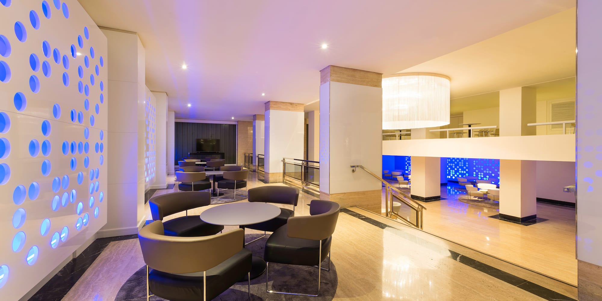 a room with a round table and chairs