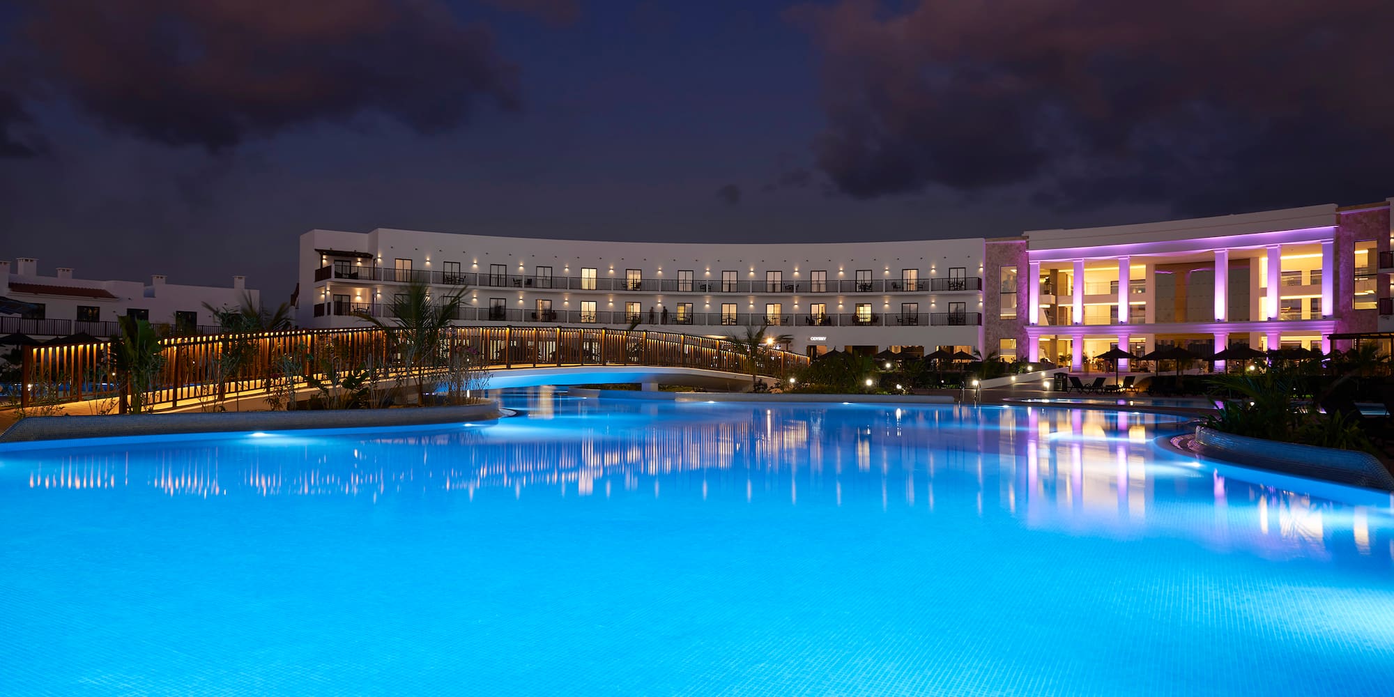 a pool with a building and a building in the background