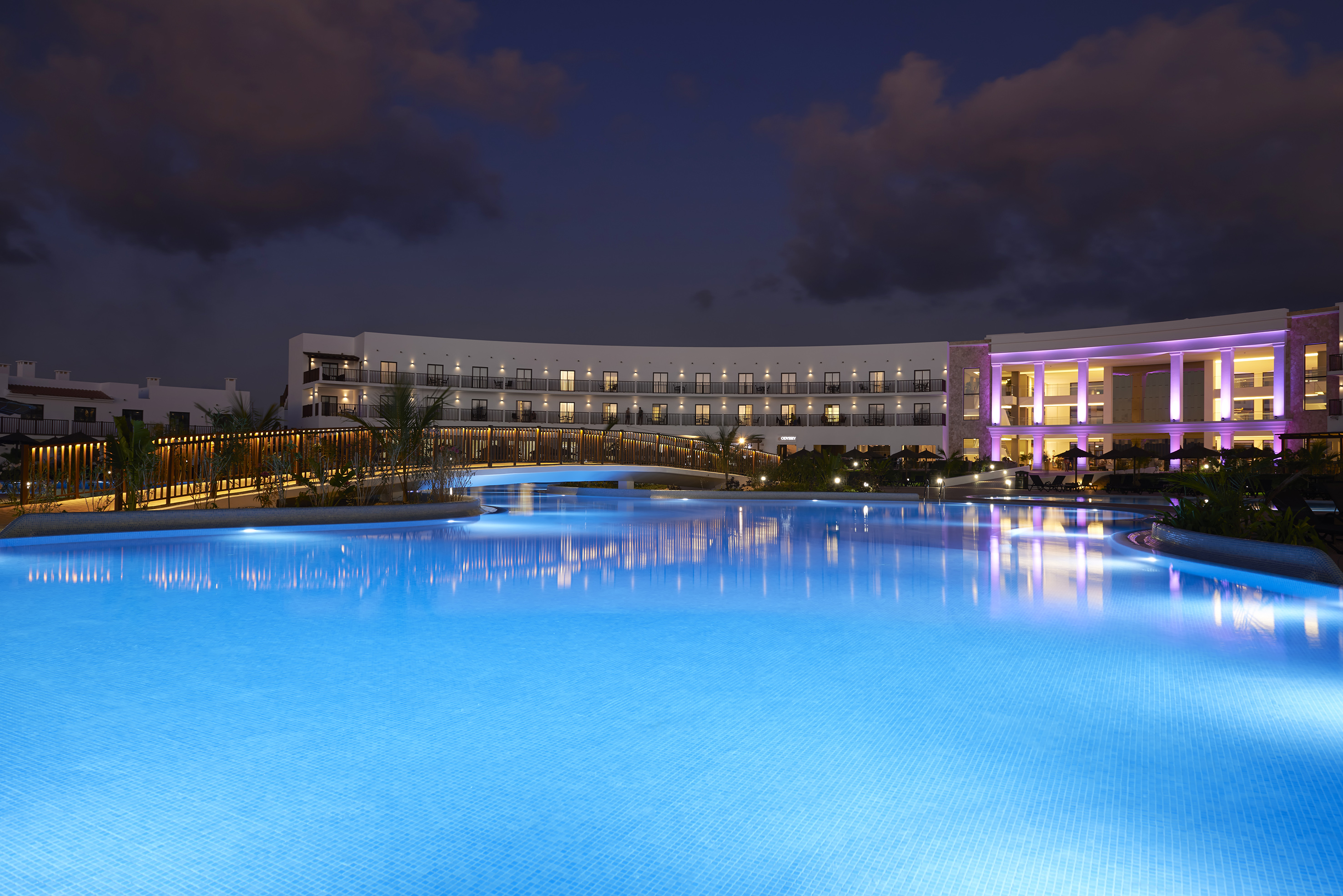 a pool with a building and a building in the background
