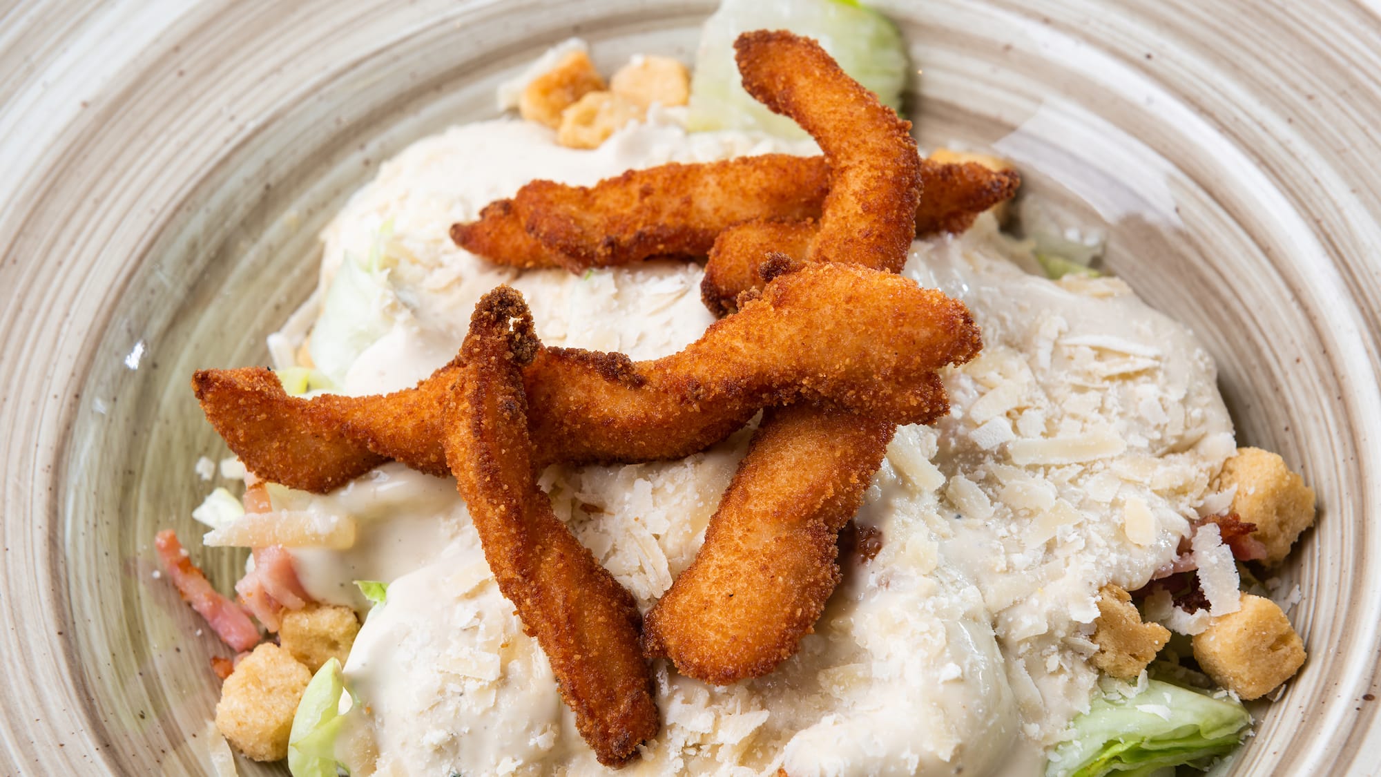 a plate of food with cheese and croutons