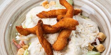 a plate of food with cheese and croutons