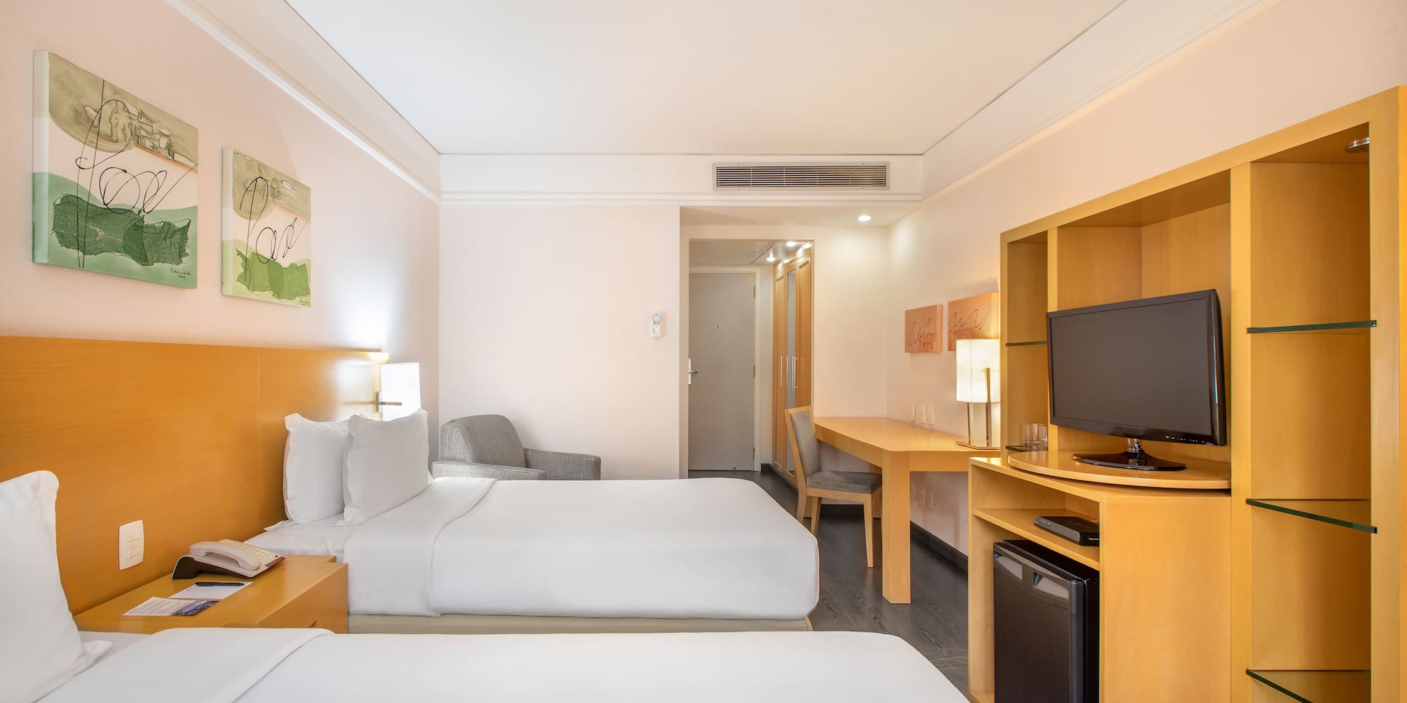 a room with two beds and a television