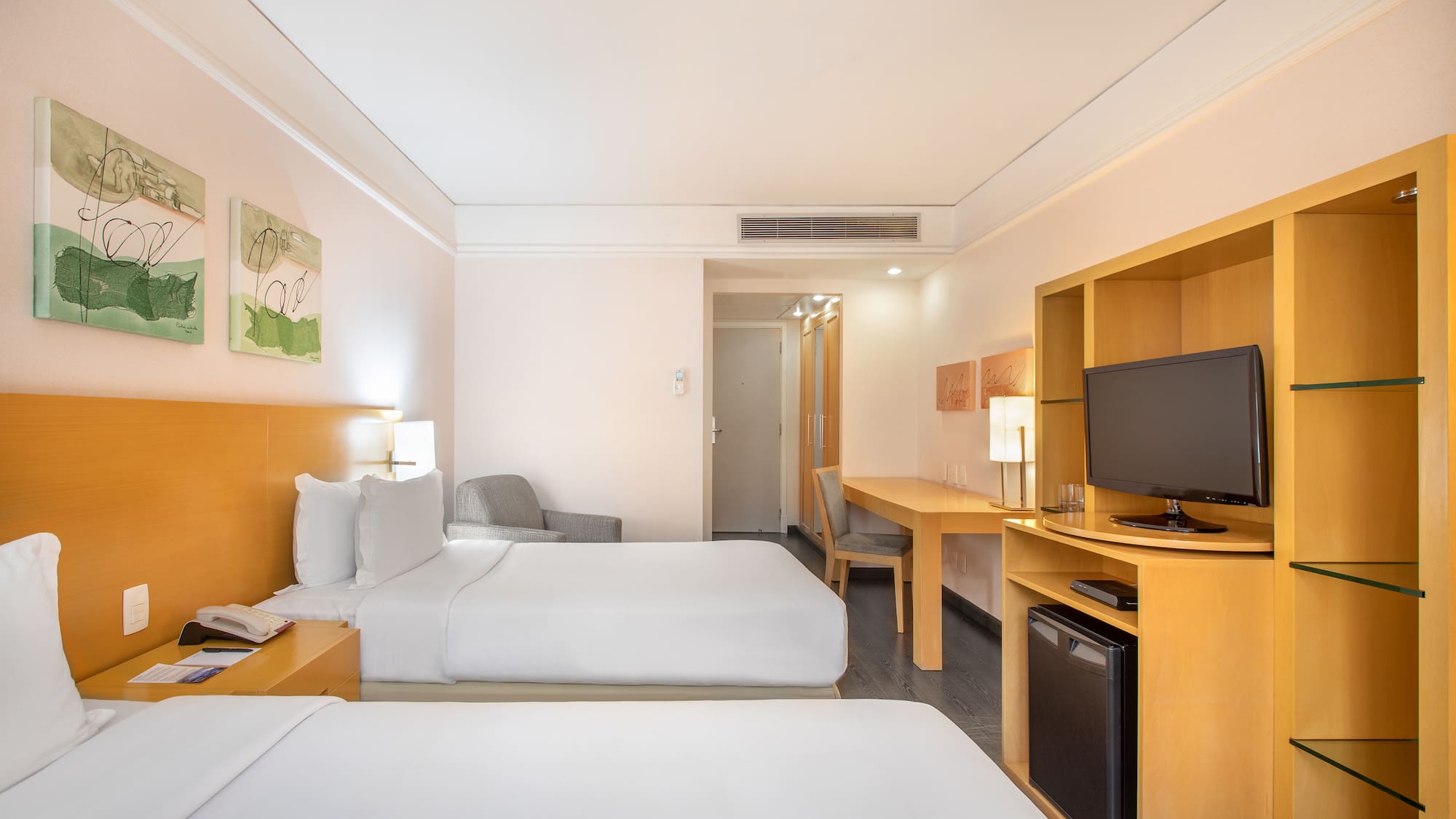 a room with two beds and a television