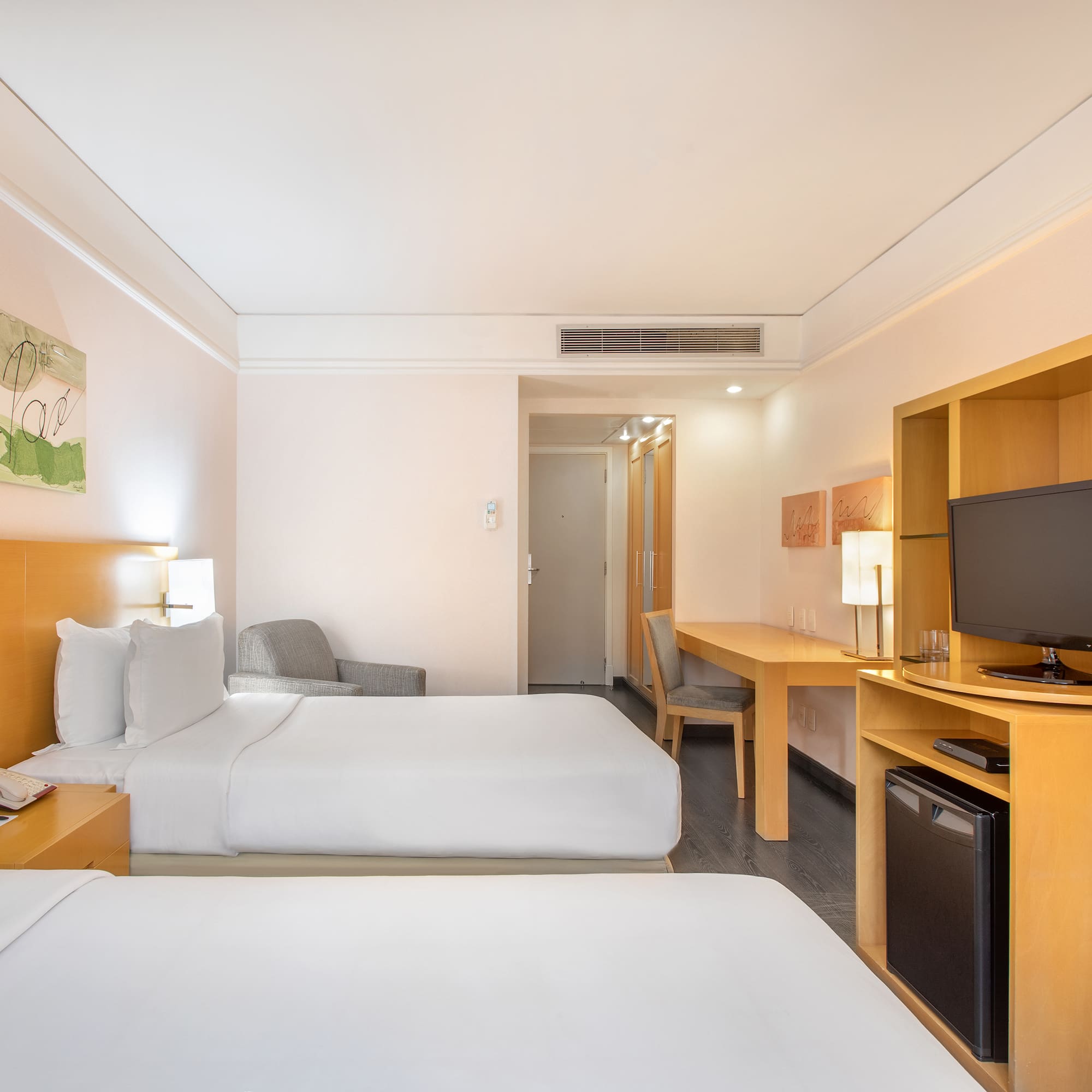 a room with two beds and a television